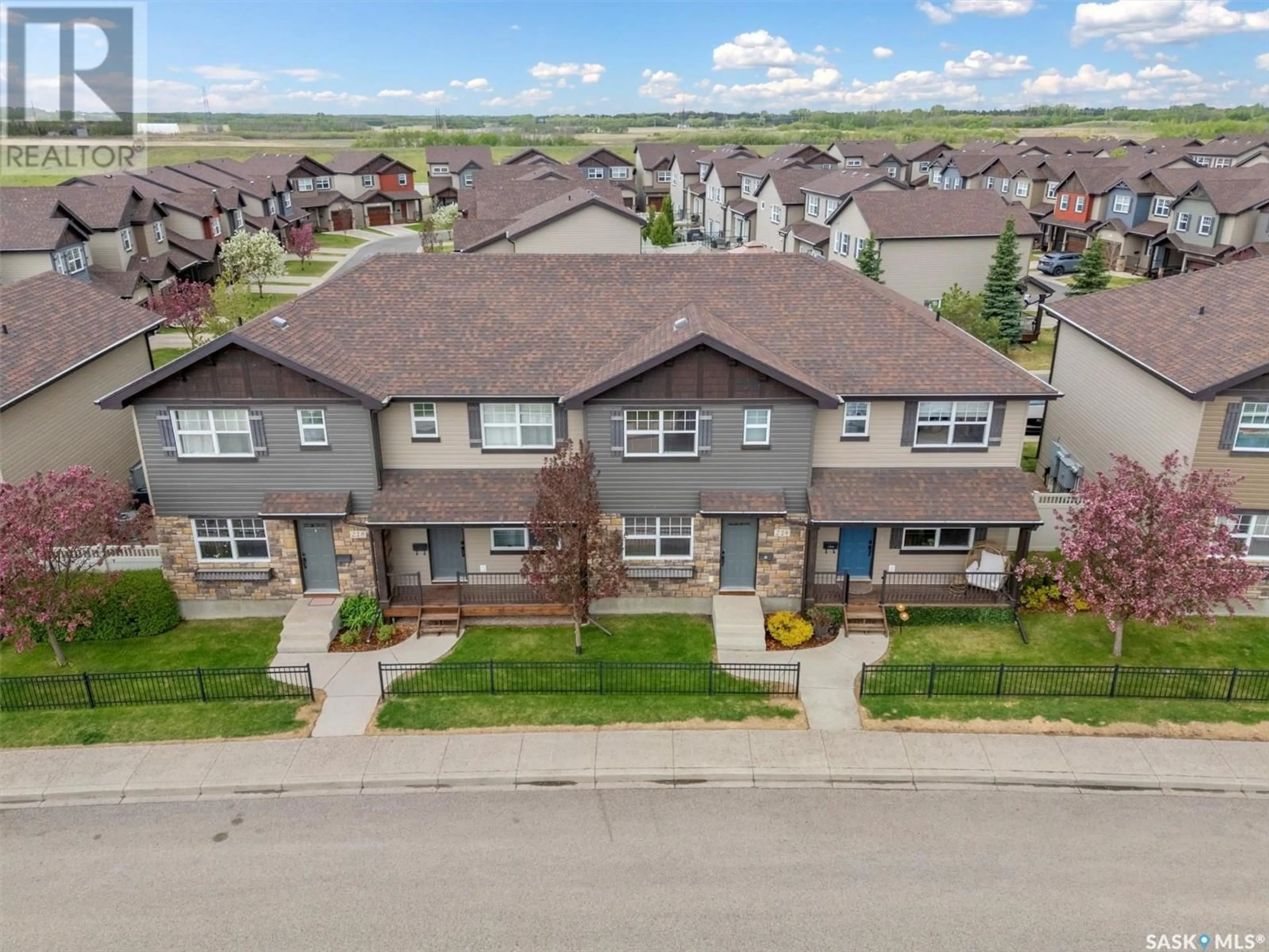 A pic from outside/outdoor area/front of a property/back of a property/a pic from drone, street for 212 LANGLOIS WAY, Saskatoon Saskatchewan S7T0L2