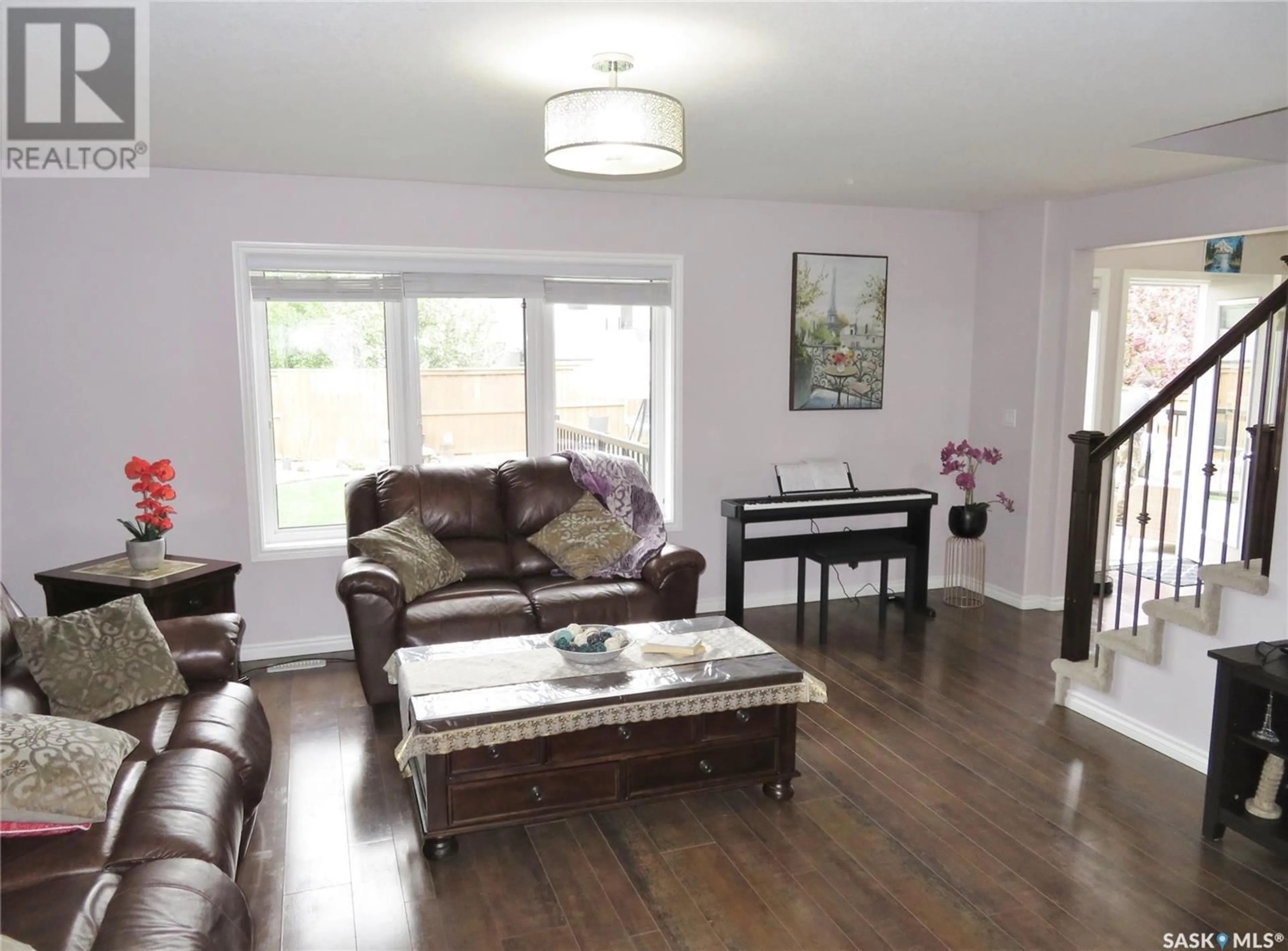Living room with furniture, wood/laminate floor for 959 HUNTER ROAD, Saskatoon Saskatchewan S7T0P9