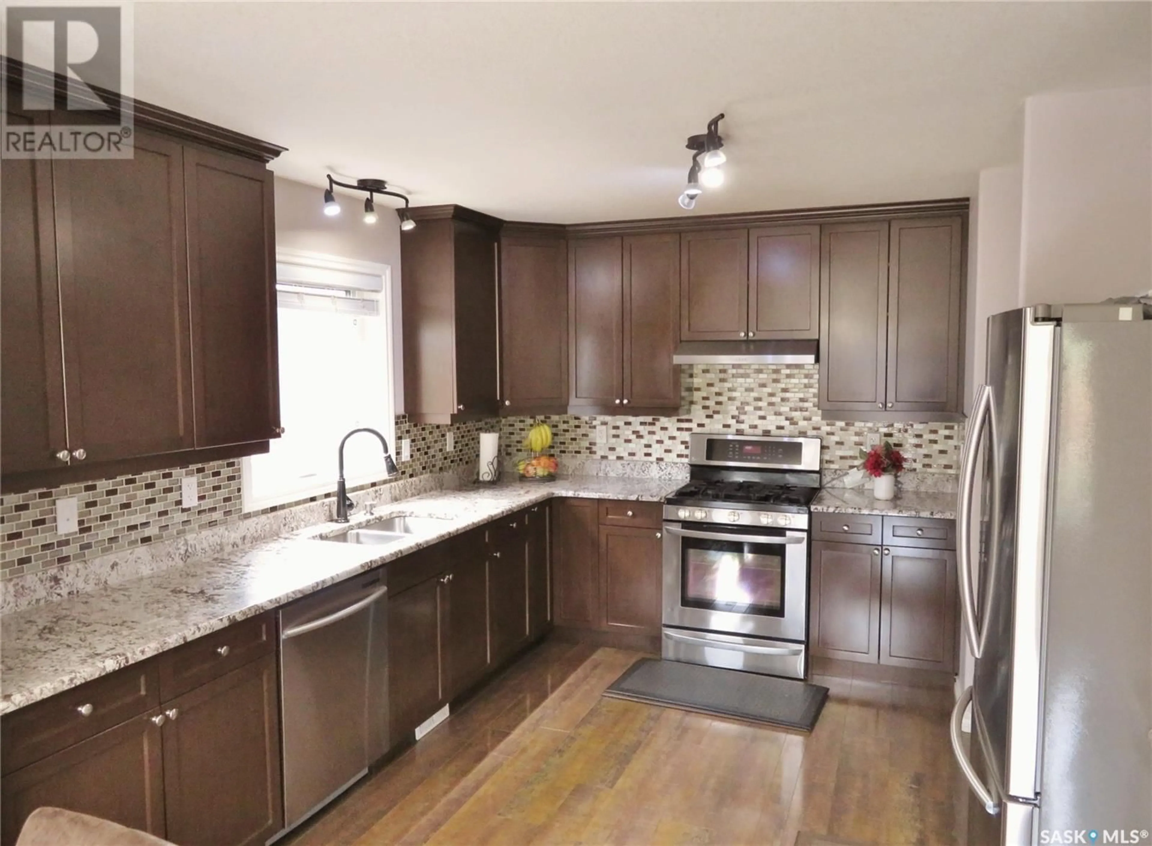Open concept kitchen, wood/laminate floor for 959 HUNTER ROAD, Saskatoon Saskatchewan S7T0P9