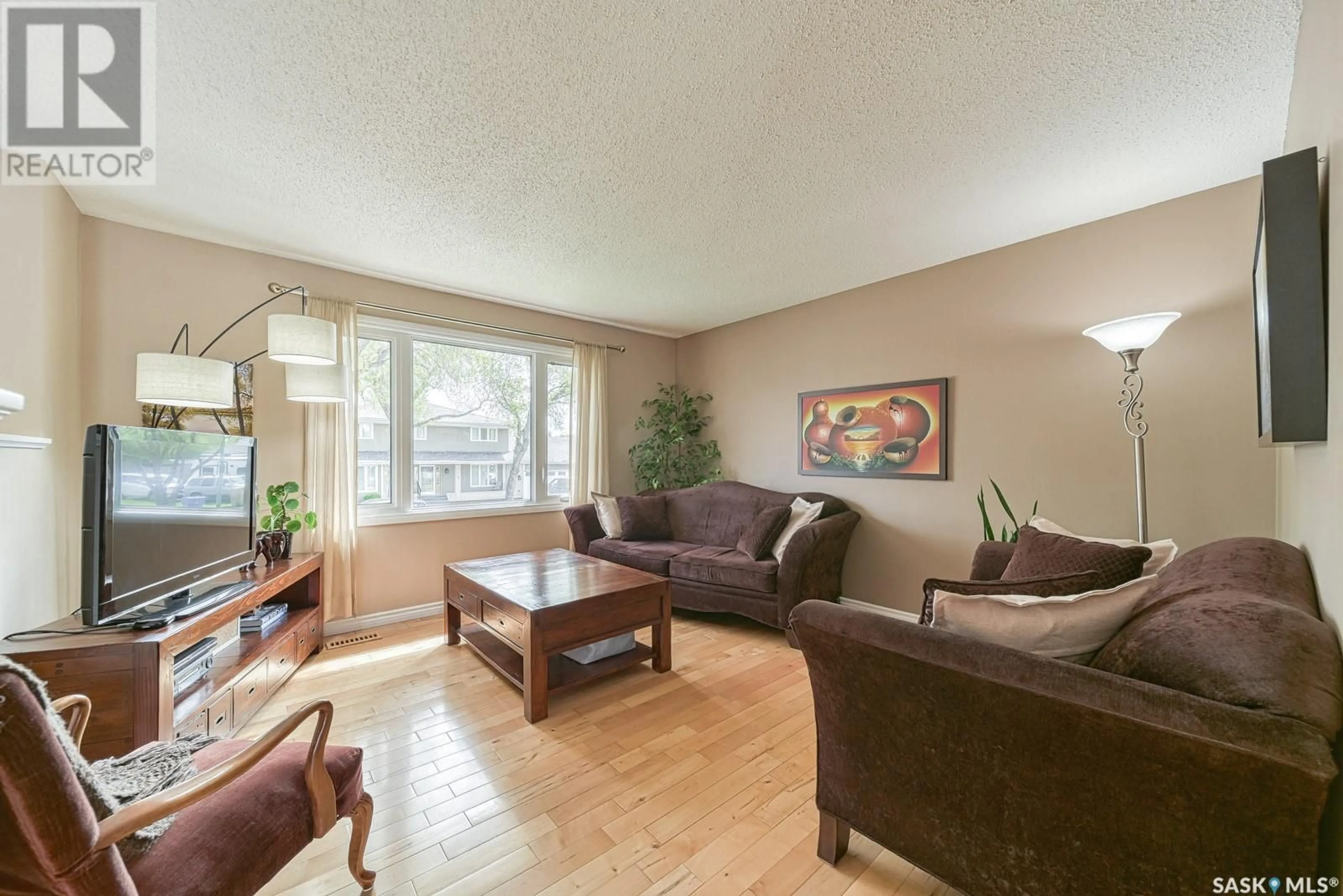 Living room with furniture, wood/laminate floor for 12 BAUERMEISTER STREET, Regina Saskatchewan S4R5N4