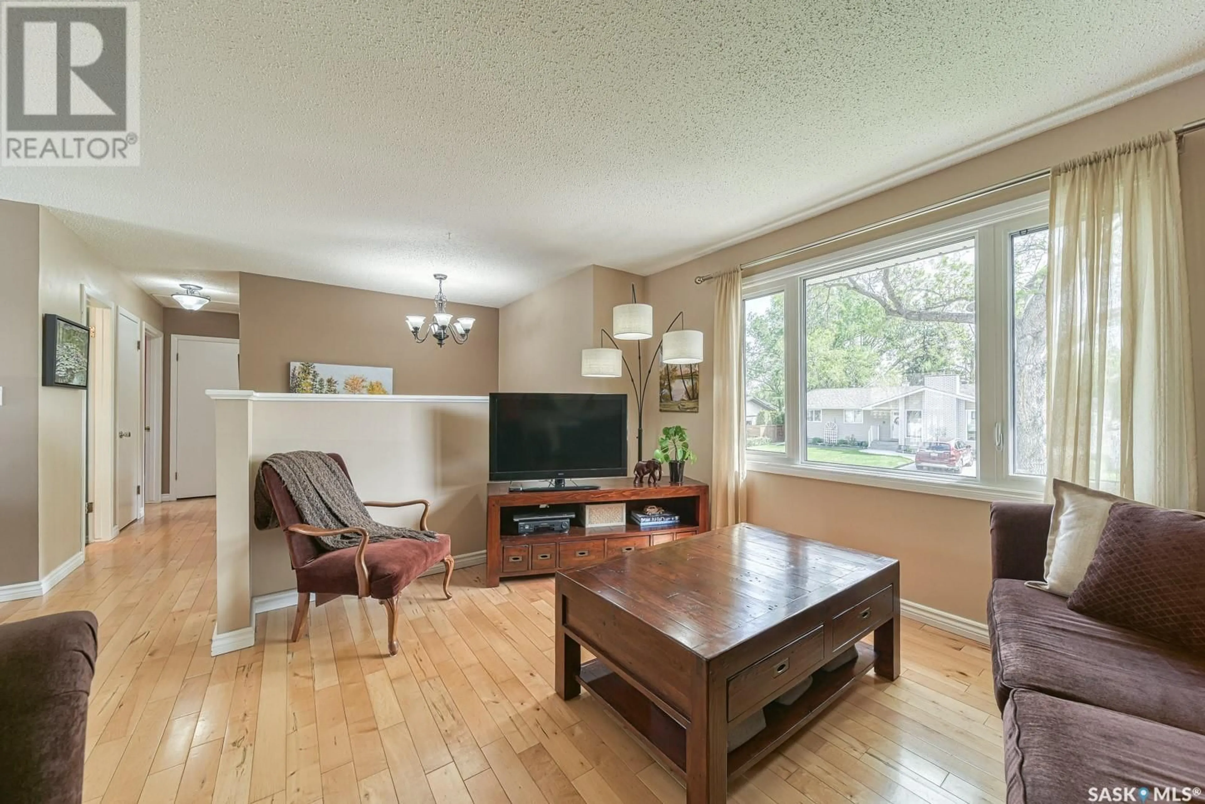 Living room with furniture, wood/laminate floor for 12 BAUERMEISTER STREET, Regina Saskatchewan S4R5N4