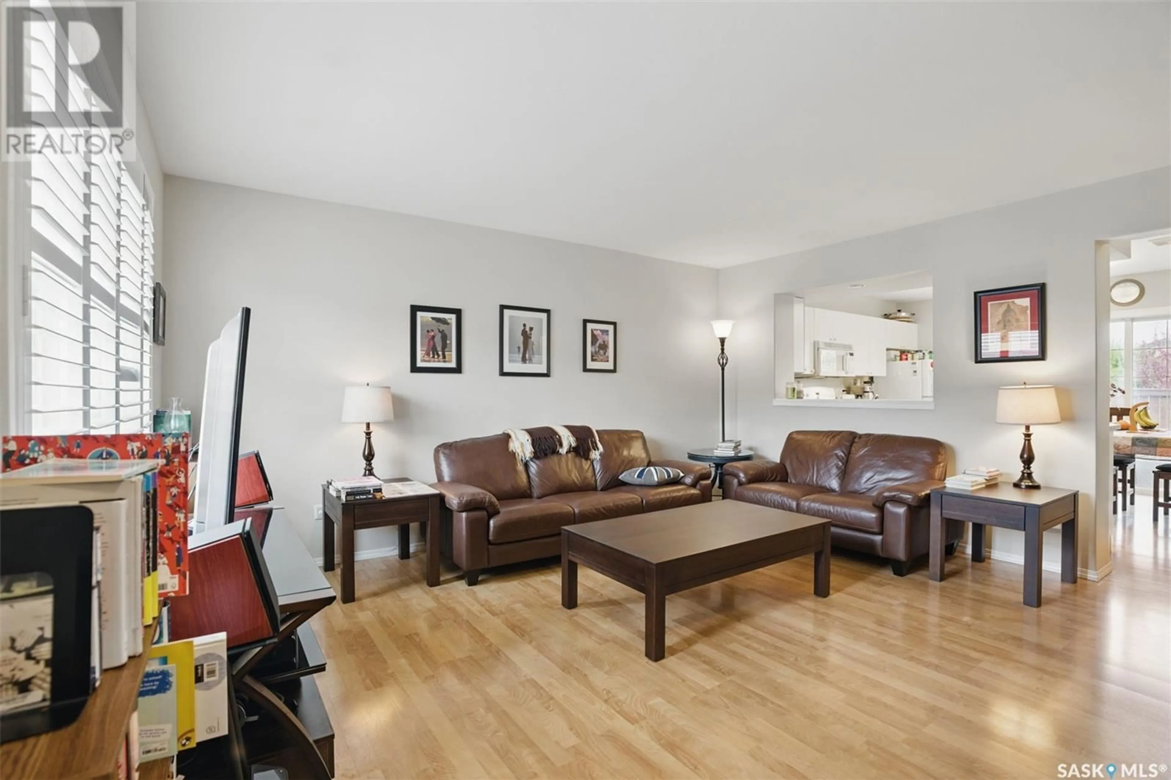 Living room with furniture, wood/laminate floor for 815 - 249 KRISTJANSON ROAD, Saskatoon Saskatchewan S7S1M6