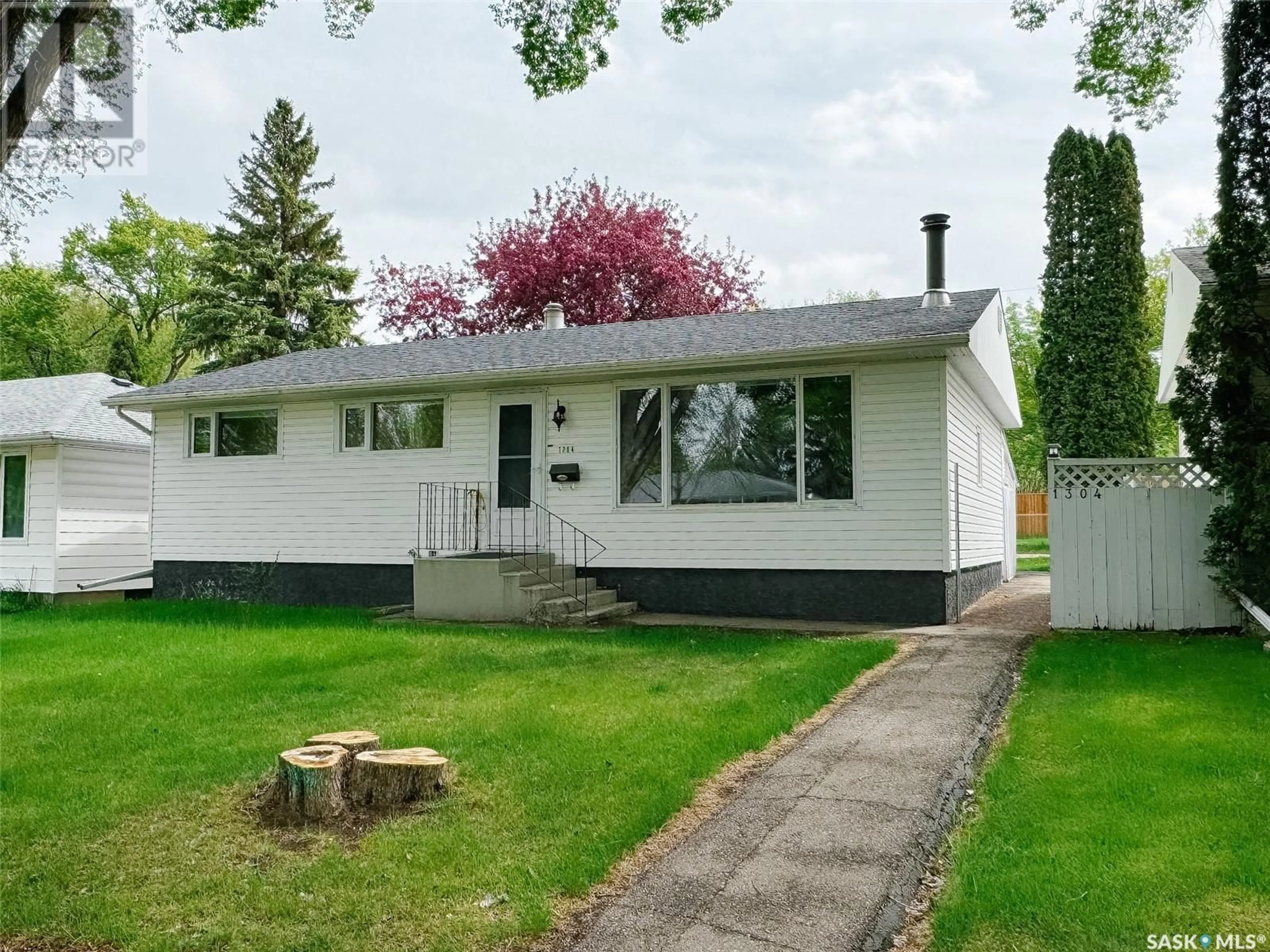 Home with vinyl exterior material, street for 1304 J AVENUE, Saskatoon Saskatchewan S7L2L8