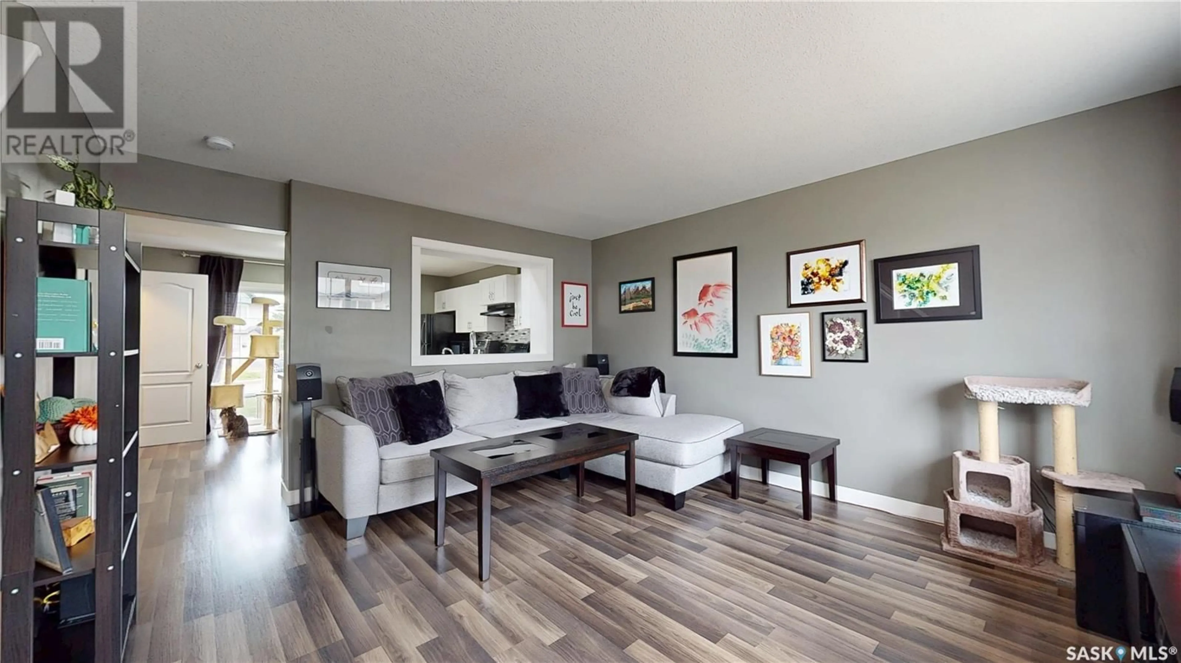 Living room with furniture, wood/laminate floor for 1272 WESSEX PLACE, Regina Saskatchewan S4N7S2
