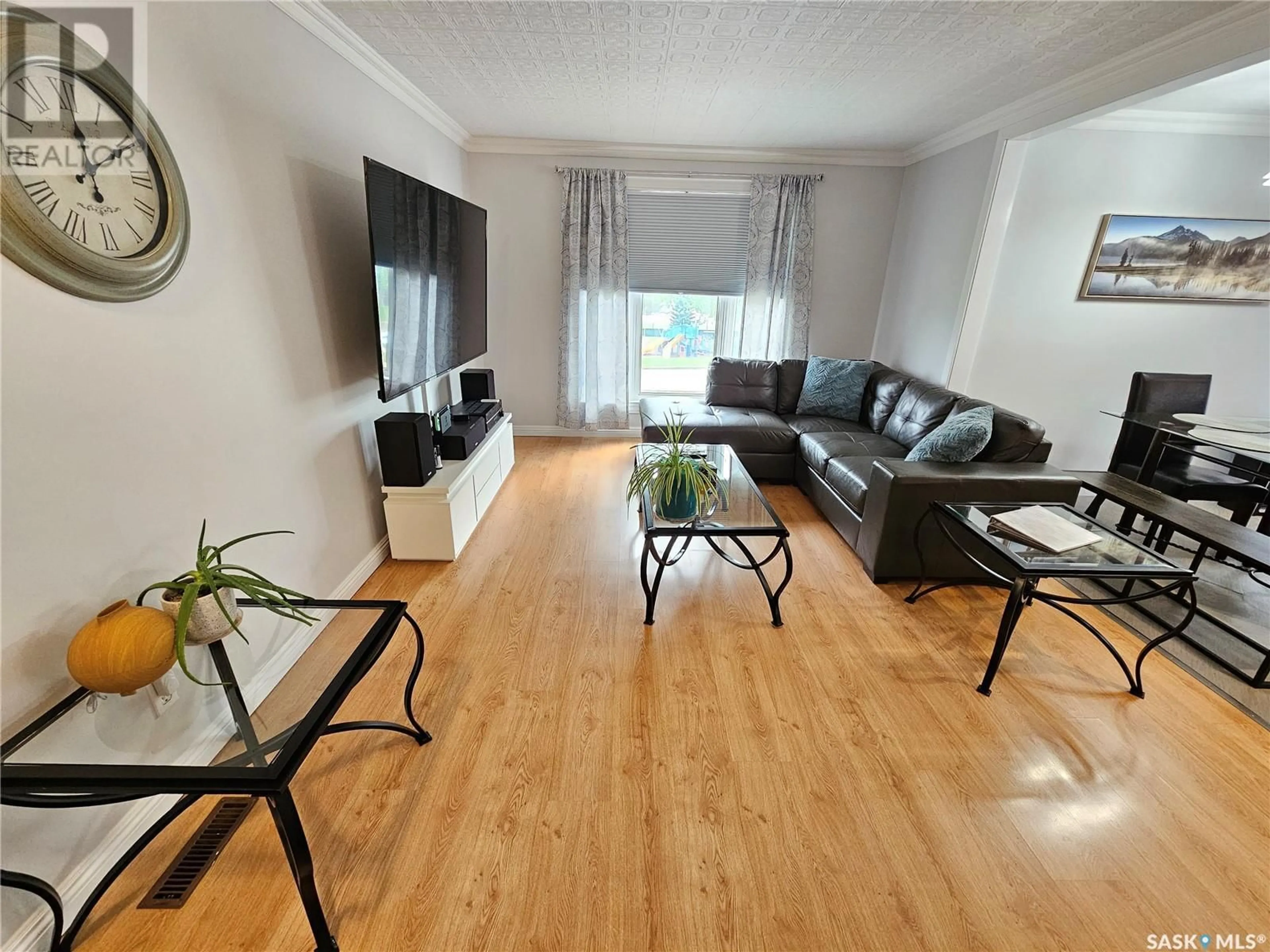 Living room with furniture, wood/laminate floor for 1010 HOCHELAGA STREET, Moose Jaw Saskatchewan S6H2H9