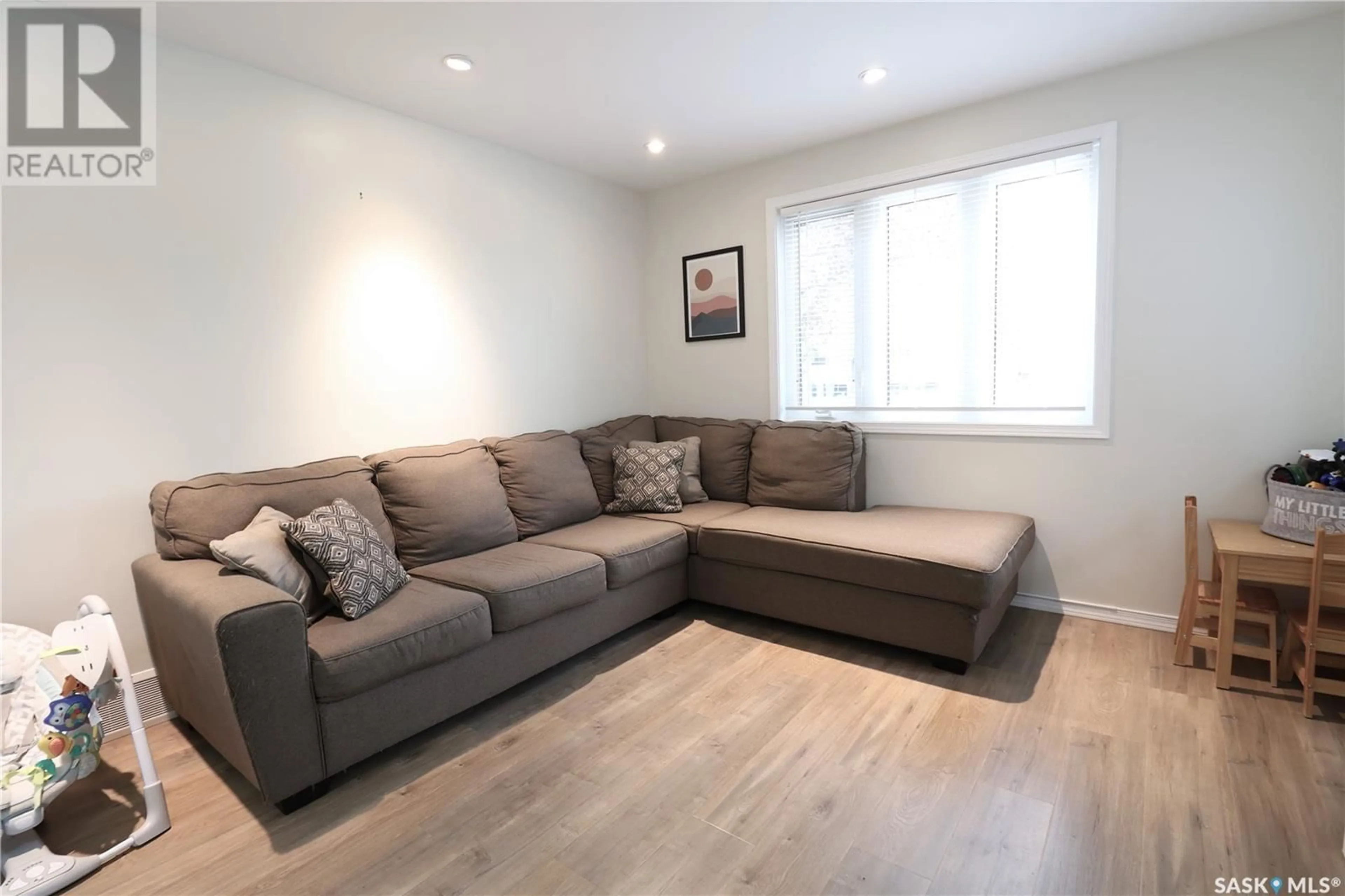 Living room with furniture, wood/laminate floor for 2526 DEWDNEY AVENUE, Regina Saskatchewan S4N4V5