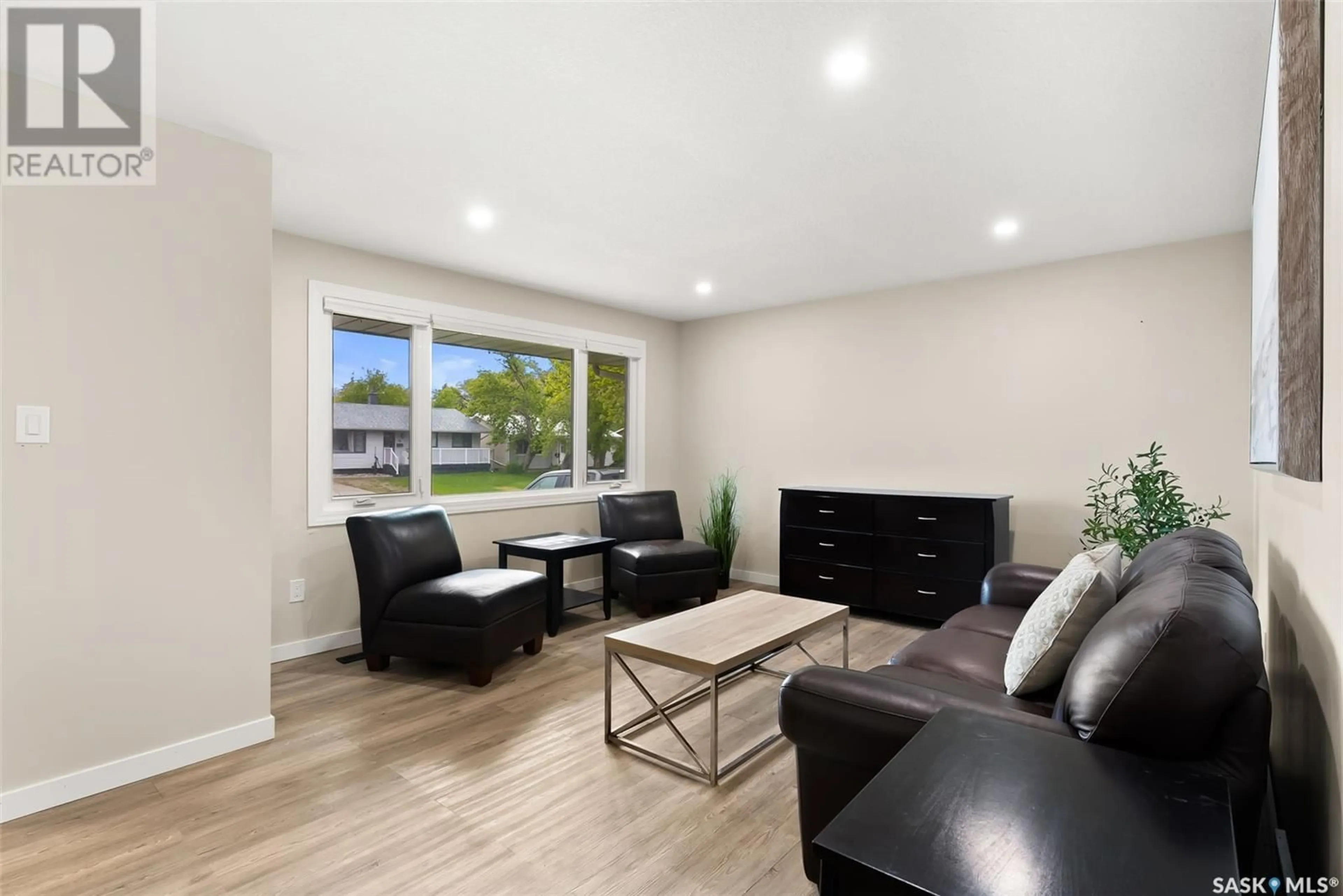 Living room with furniture, wood/laminate floor for 31 CANNON STREET, Regina Saskatchewan S4N1L7