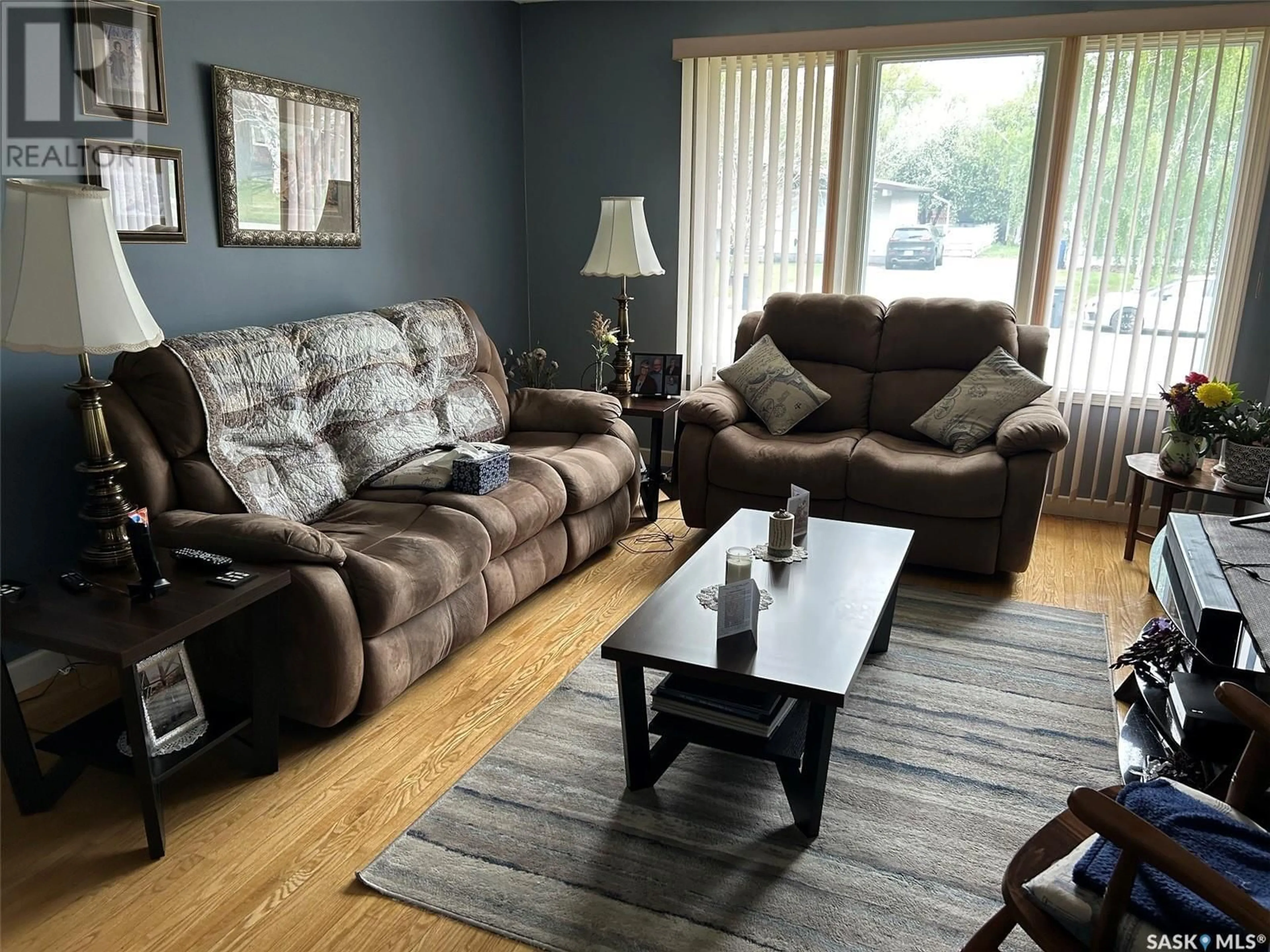Living room with furniture, wood/laminate floor for 8916 17TH AVENUE, North Battleford Saskatchewan S9A2T9