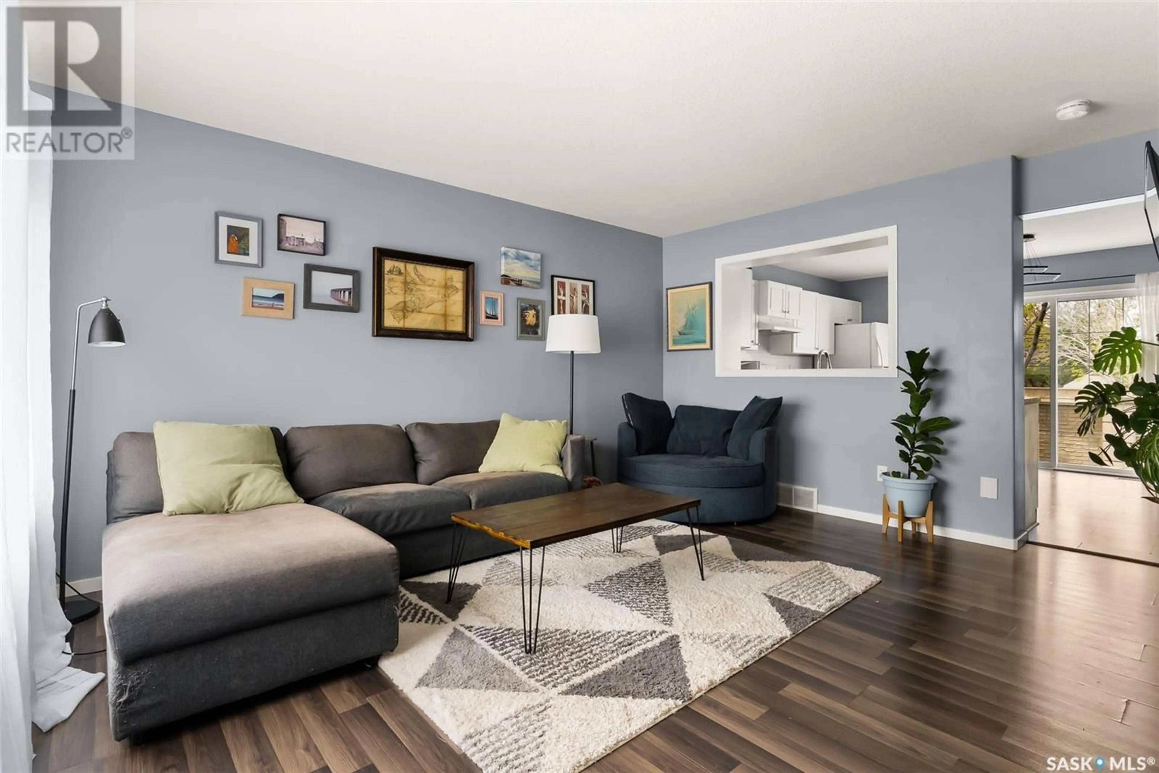 Living room with furniture, wood/laminate floor for 2704 CRANBOURN CRESCENT, Regina Saskatchewan S4V3C1