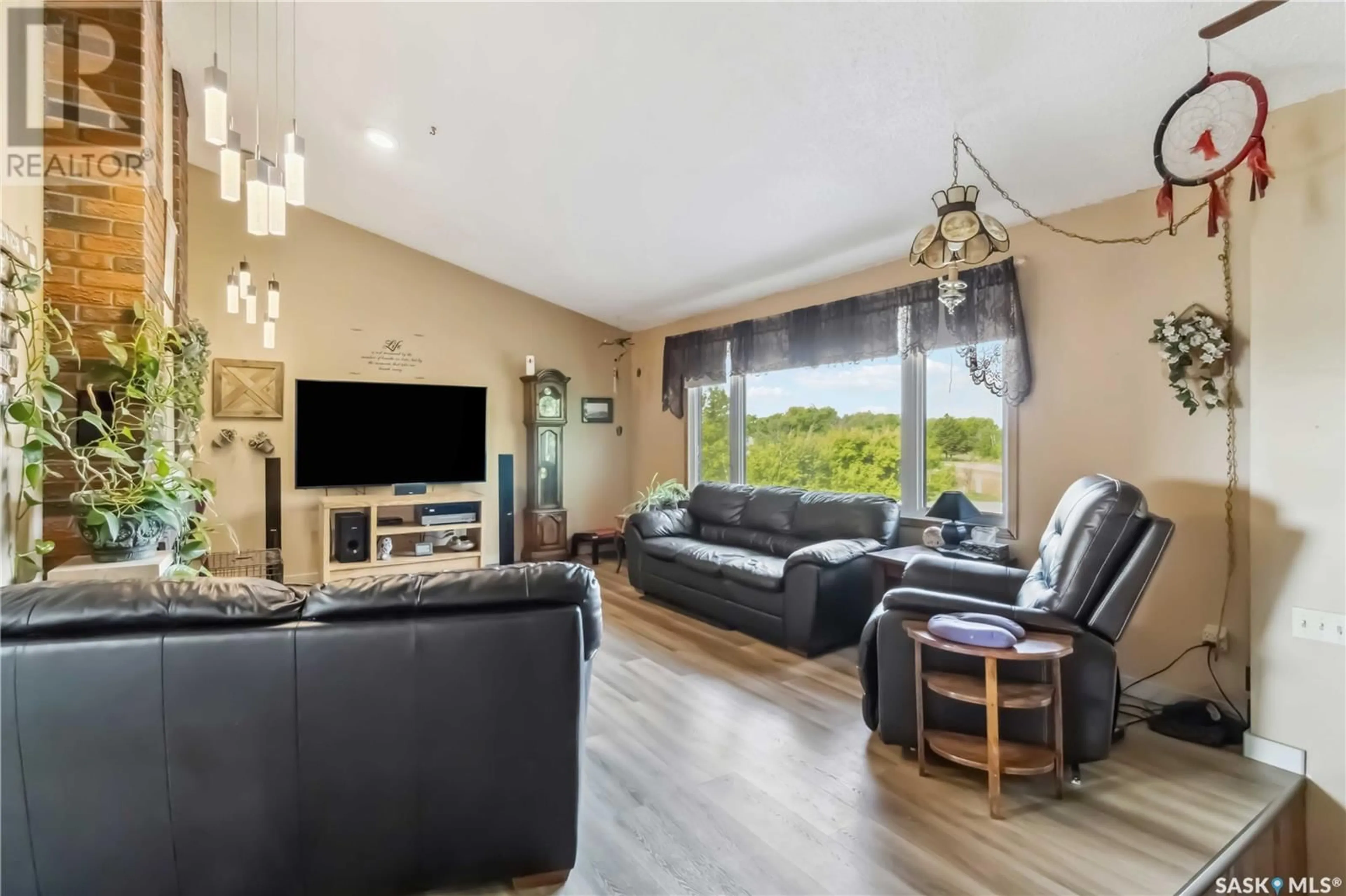 Living room with furniture, wood/laminate floor for BERGER ACREAGE, Vanscoy Rm No. 345 Saskatchewan S0K1V0