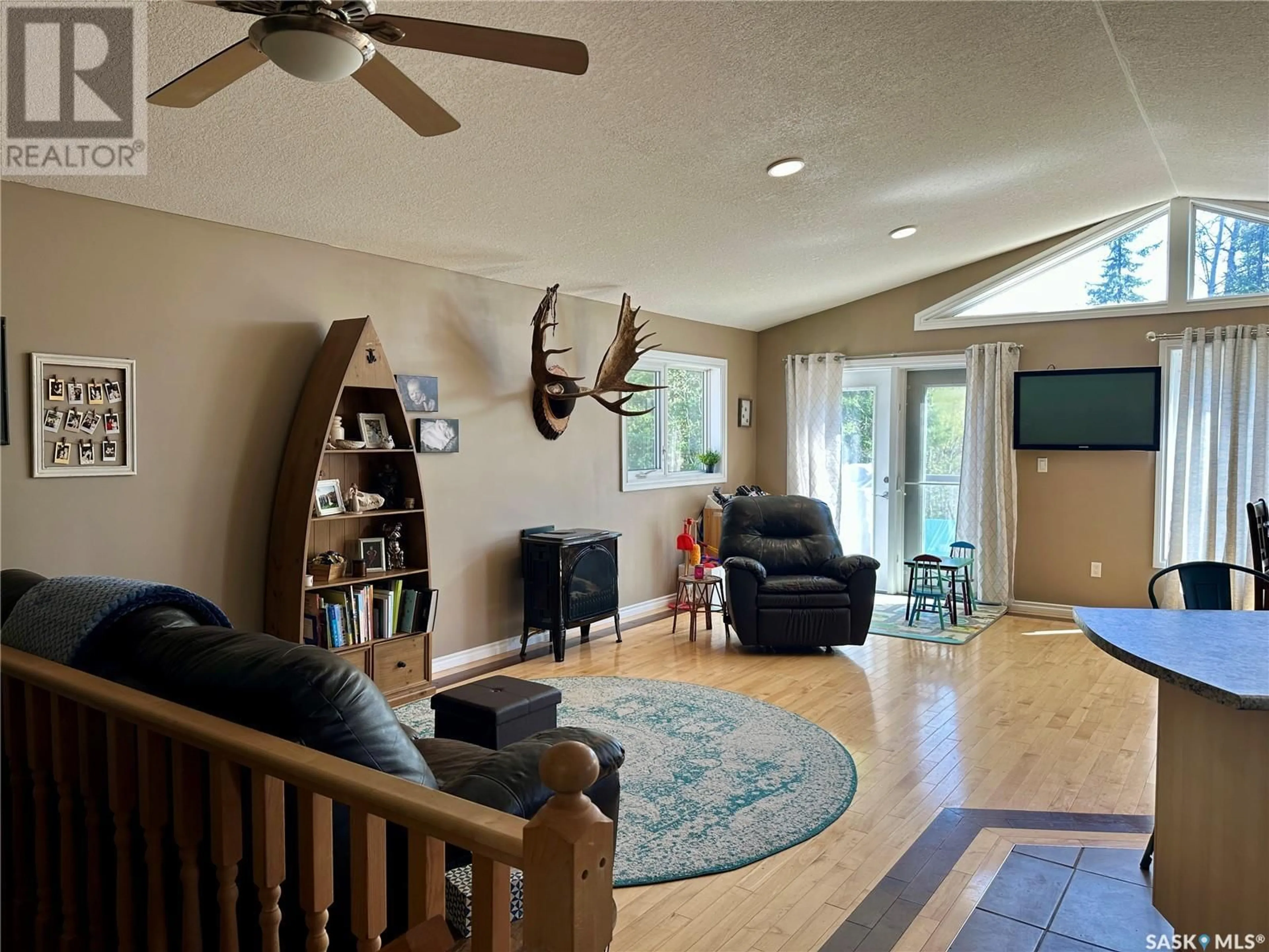 Living room with furniture, wood/laminate floor for 174 EAGLE POINT DRIVE, La Ronge Saskatchewan S0J1L0