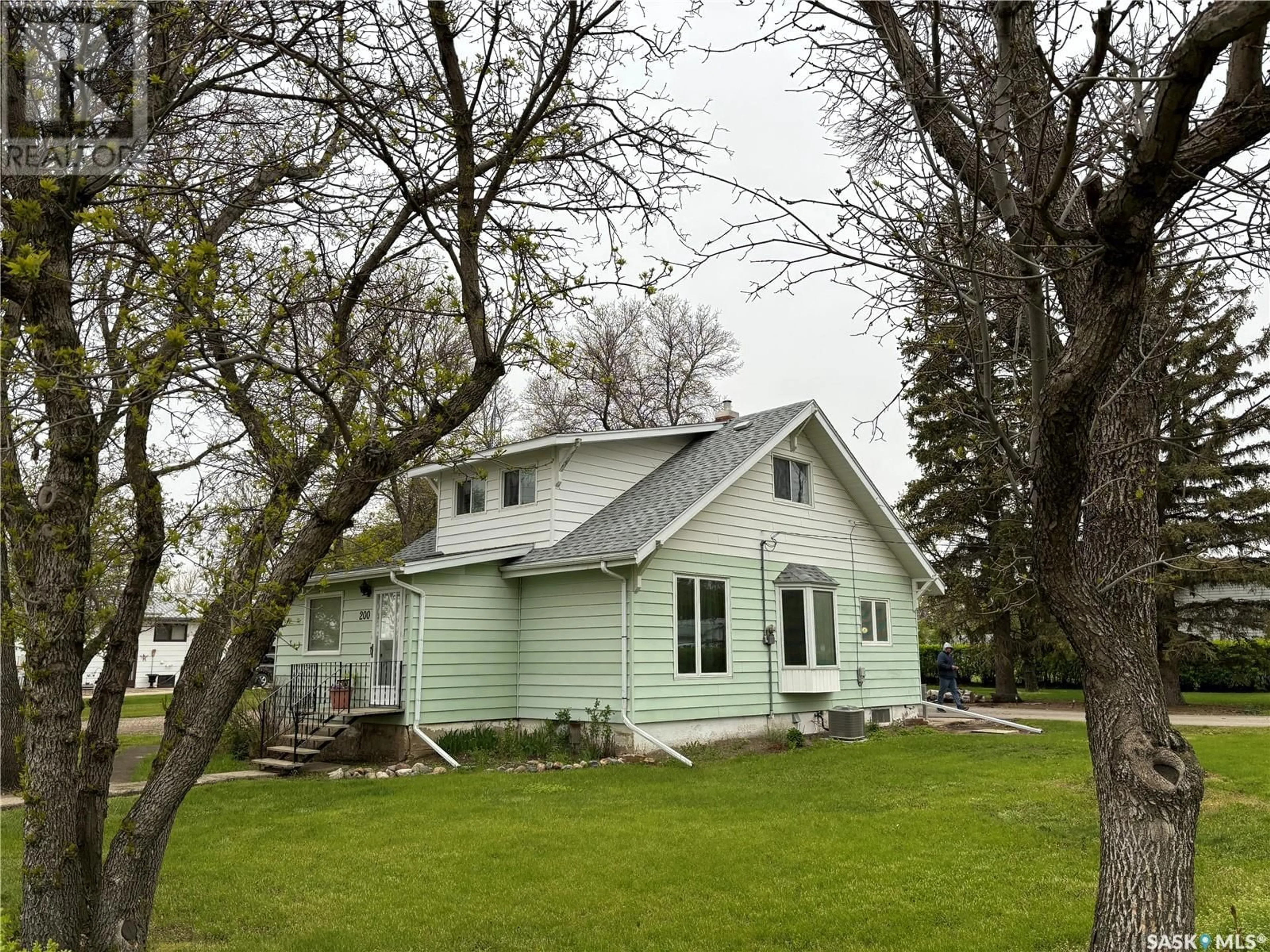 Home with vinyl exterior material, street for 200 1ST STREET, Dinsmore Saskatchewan S0L0T0