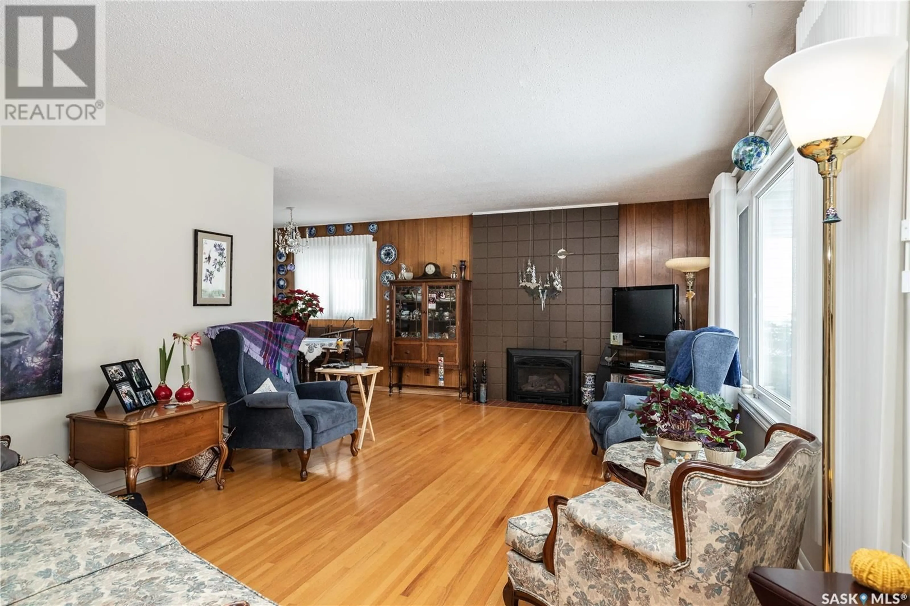 Living room with furniture, wood/laminate floor for 1813 MADDEN AVENUE, Saskatoon Saskatchewan S7H3M7
