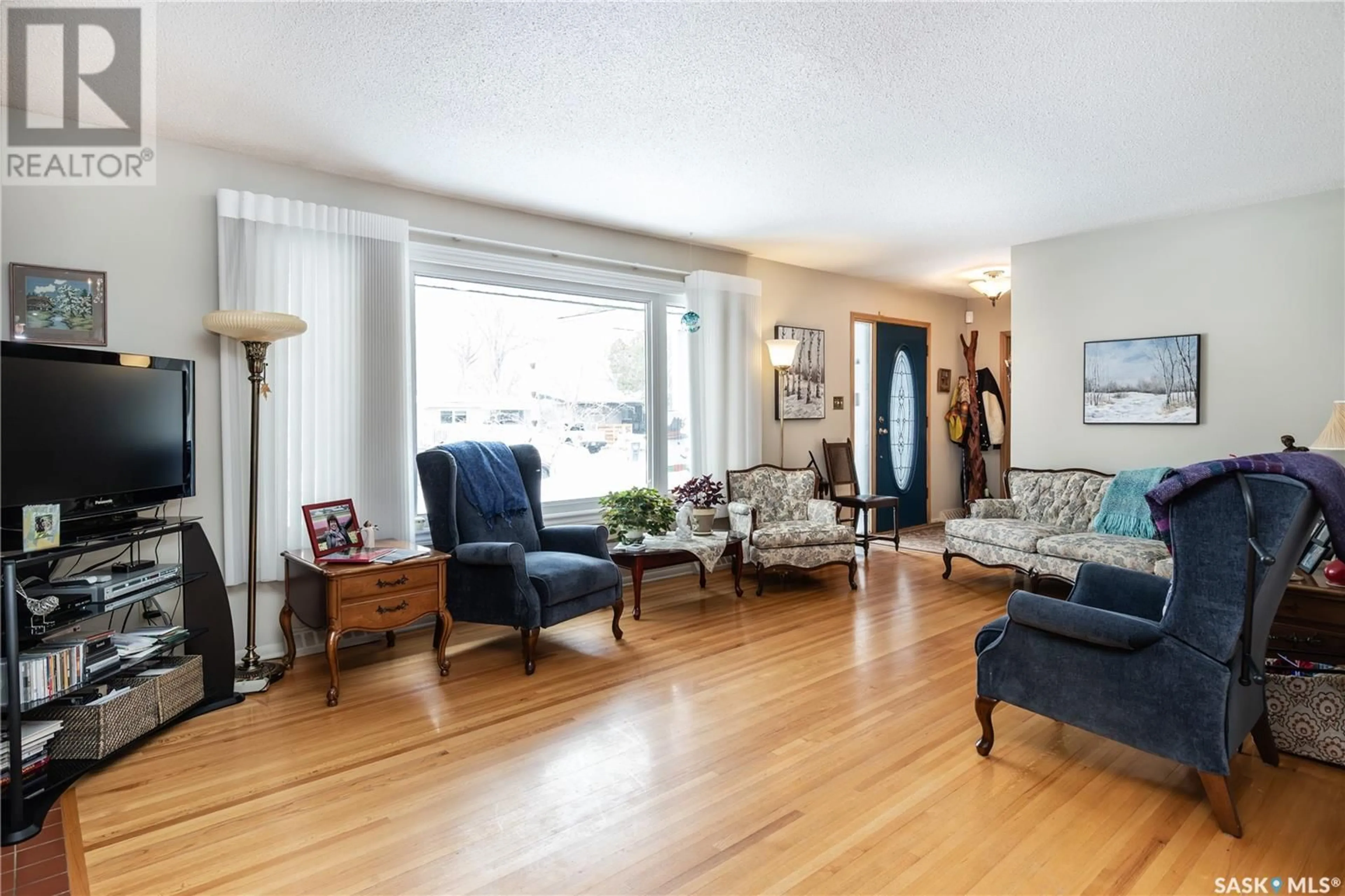 Living room with furniture, wood/laminate floor for 1813 MADDEN AVENUE, Saskatoon Saskatchewan S7H3M7