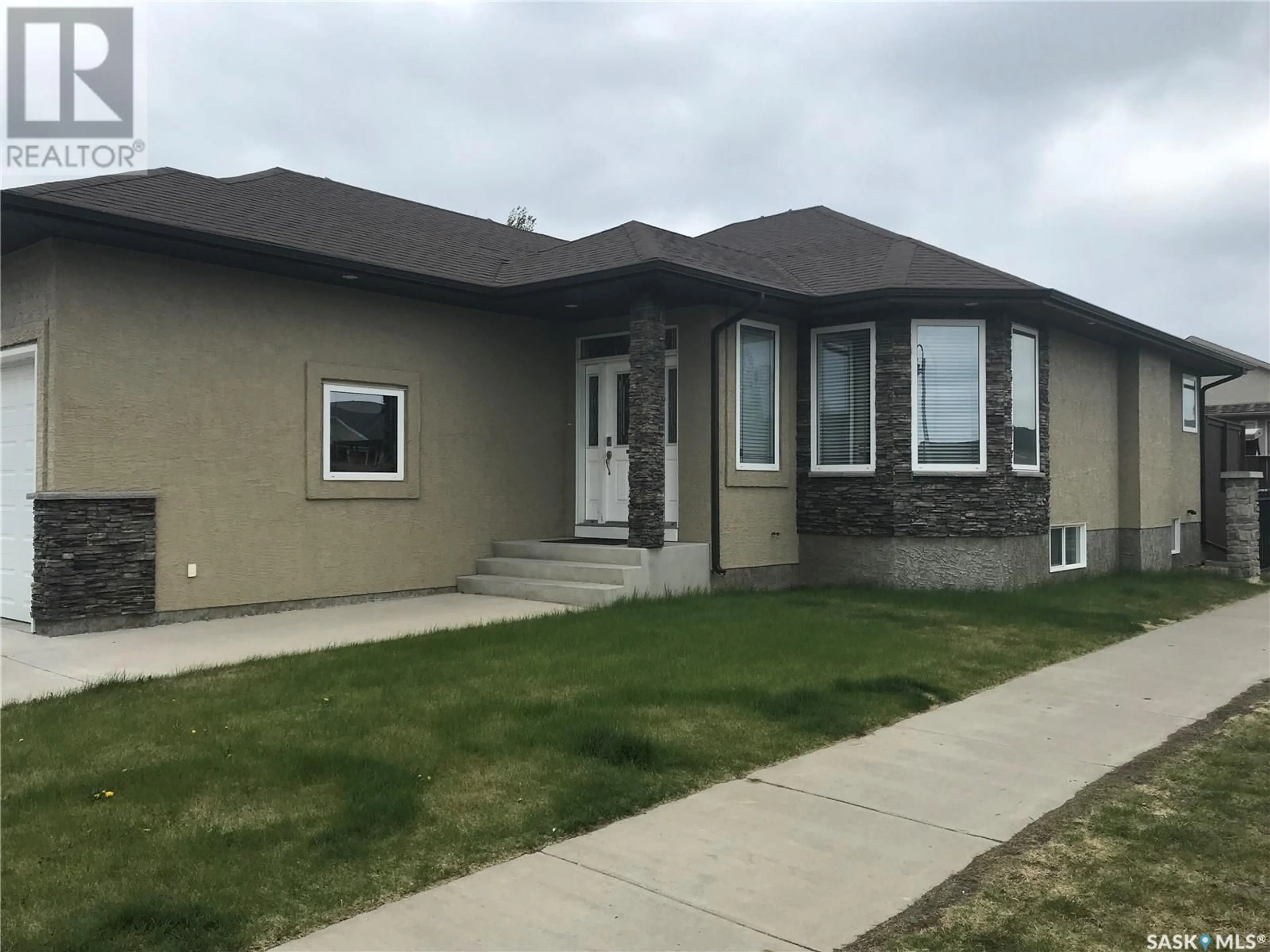 Home with vinyl exterior material, street for 102 ASSALY STREET, Saskatoon Saskatchewan S7T0E4