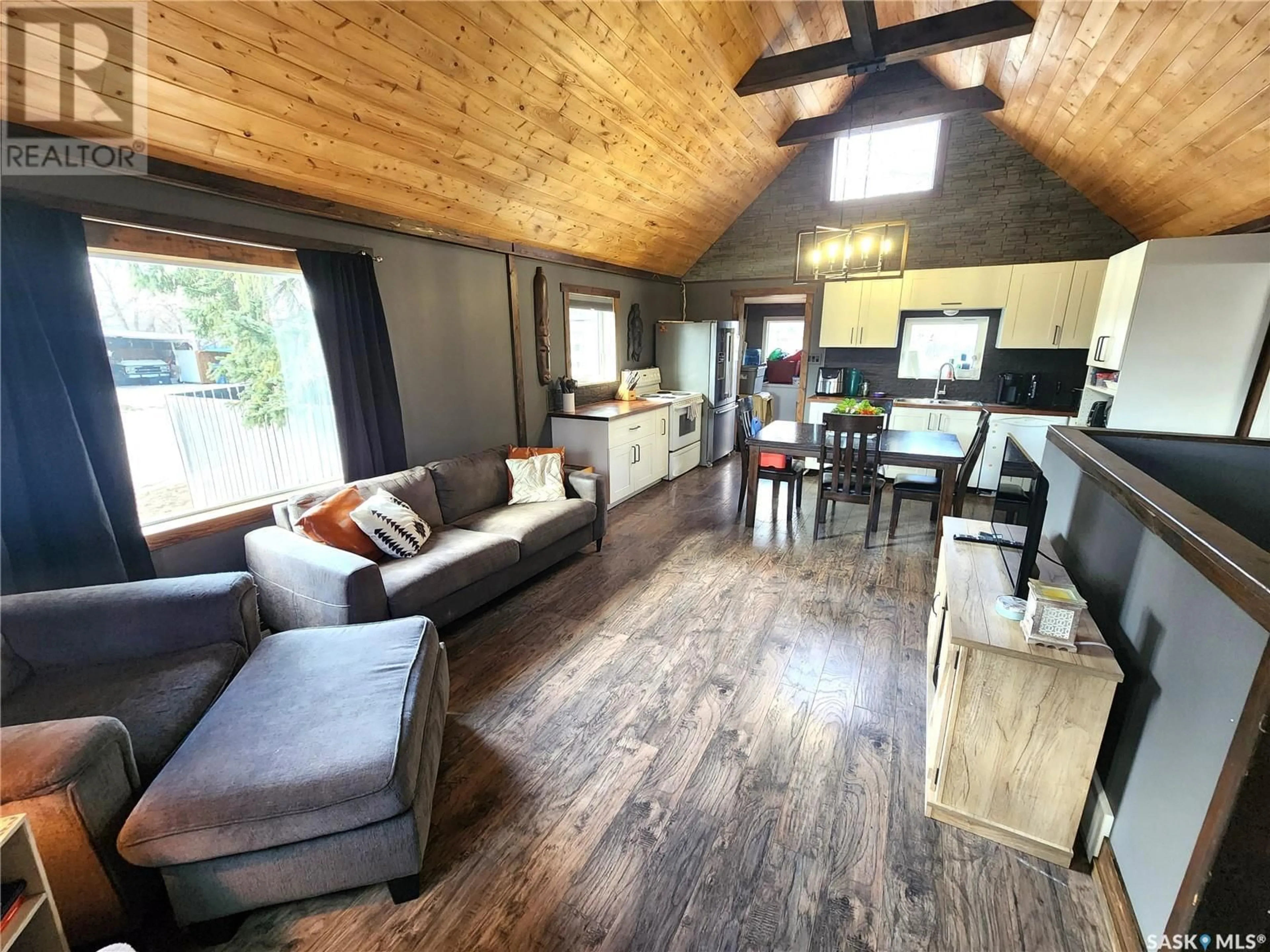 Living room with furniture, wood/laminate floor for 317 2ND STREET, Estevan Saskatchewan S4A0K2