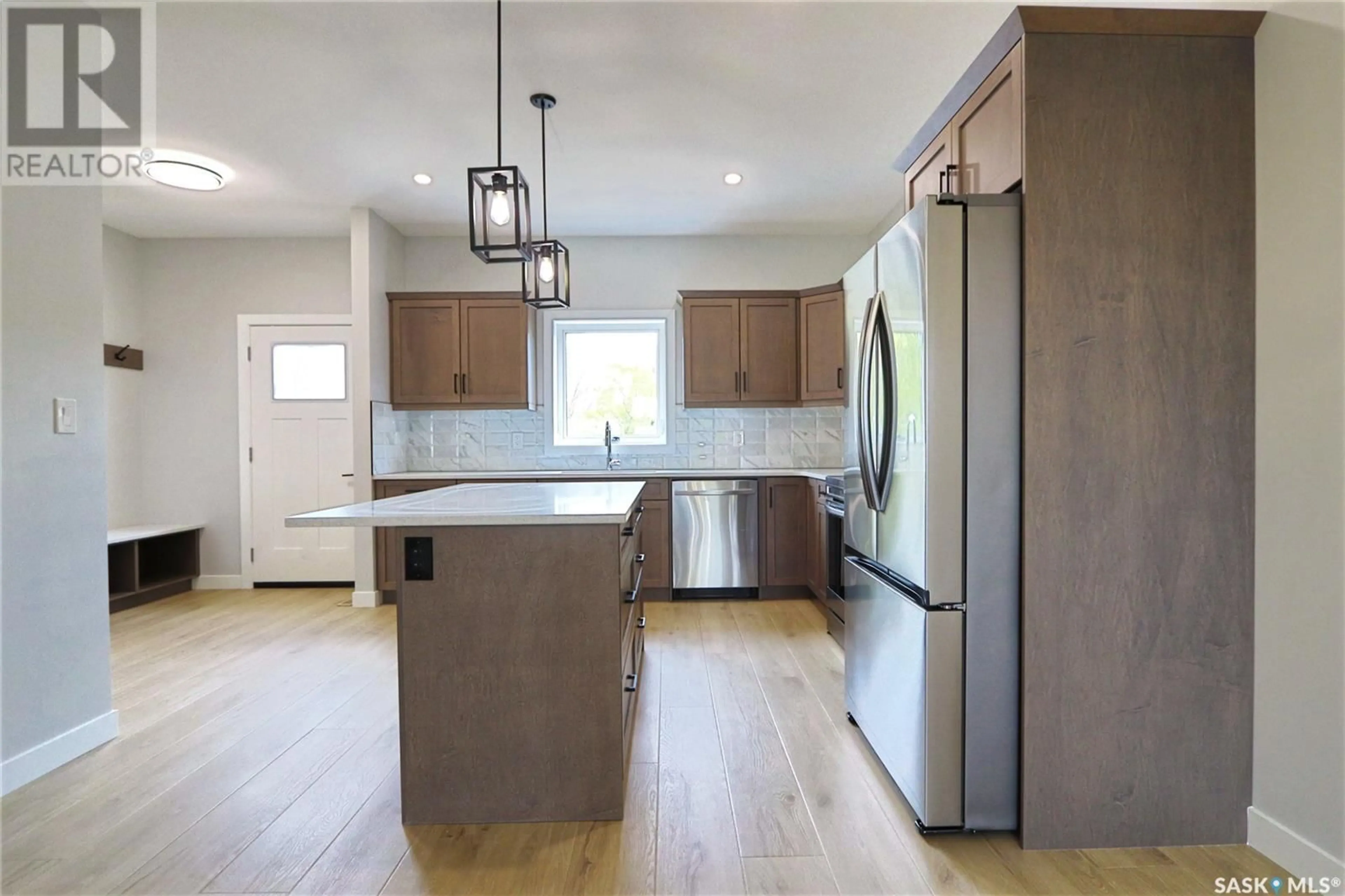 Open concept kitchen, wood/laminate floor for 2471 MCARA STREET, Regina Saskatchewan S4N2W6