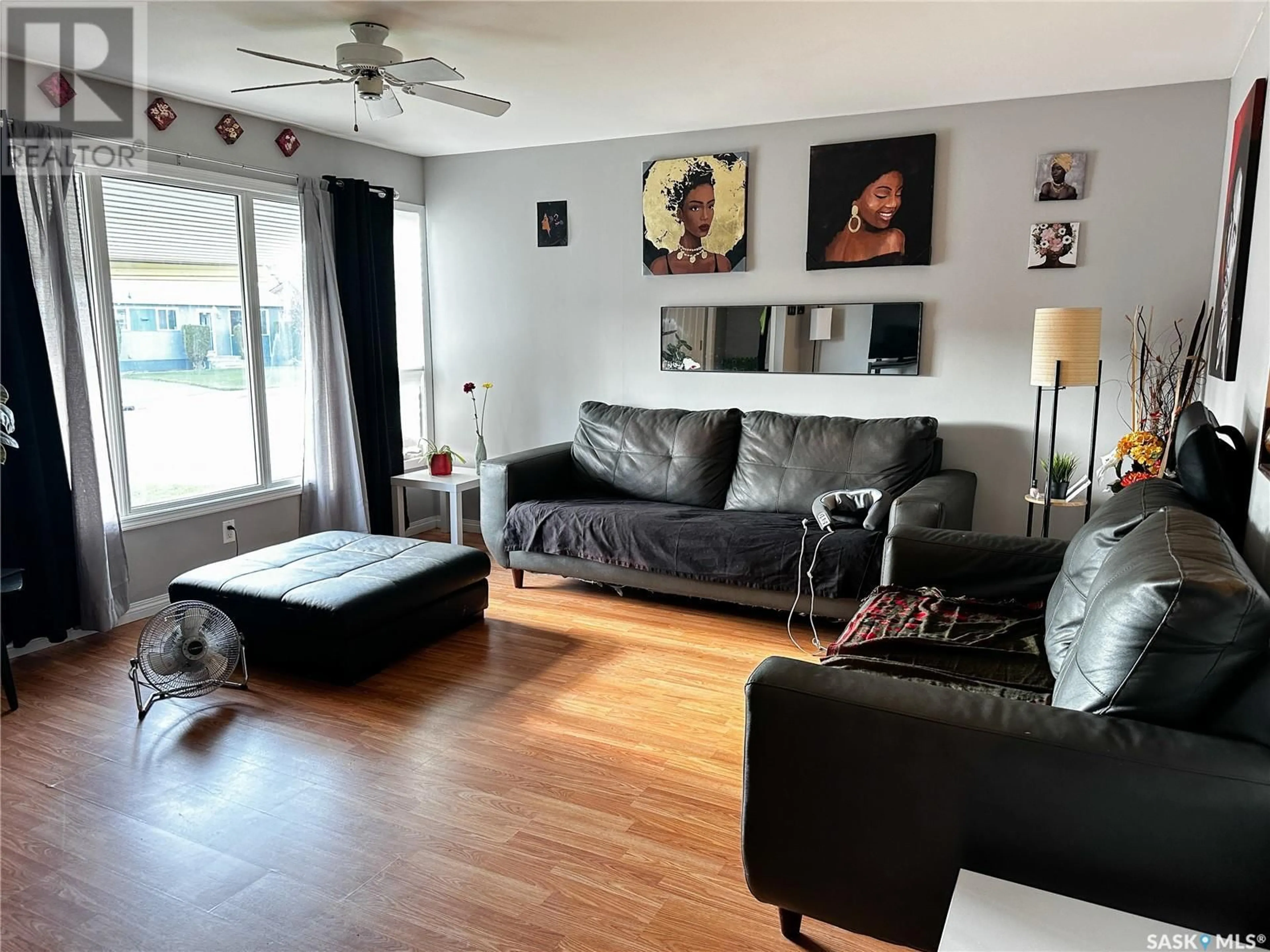 Living room with furniture, wood/laminate floor for 2110 101ST CRESCENT, North Battleford Saskatchewan S9A1C3