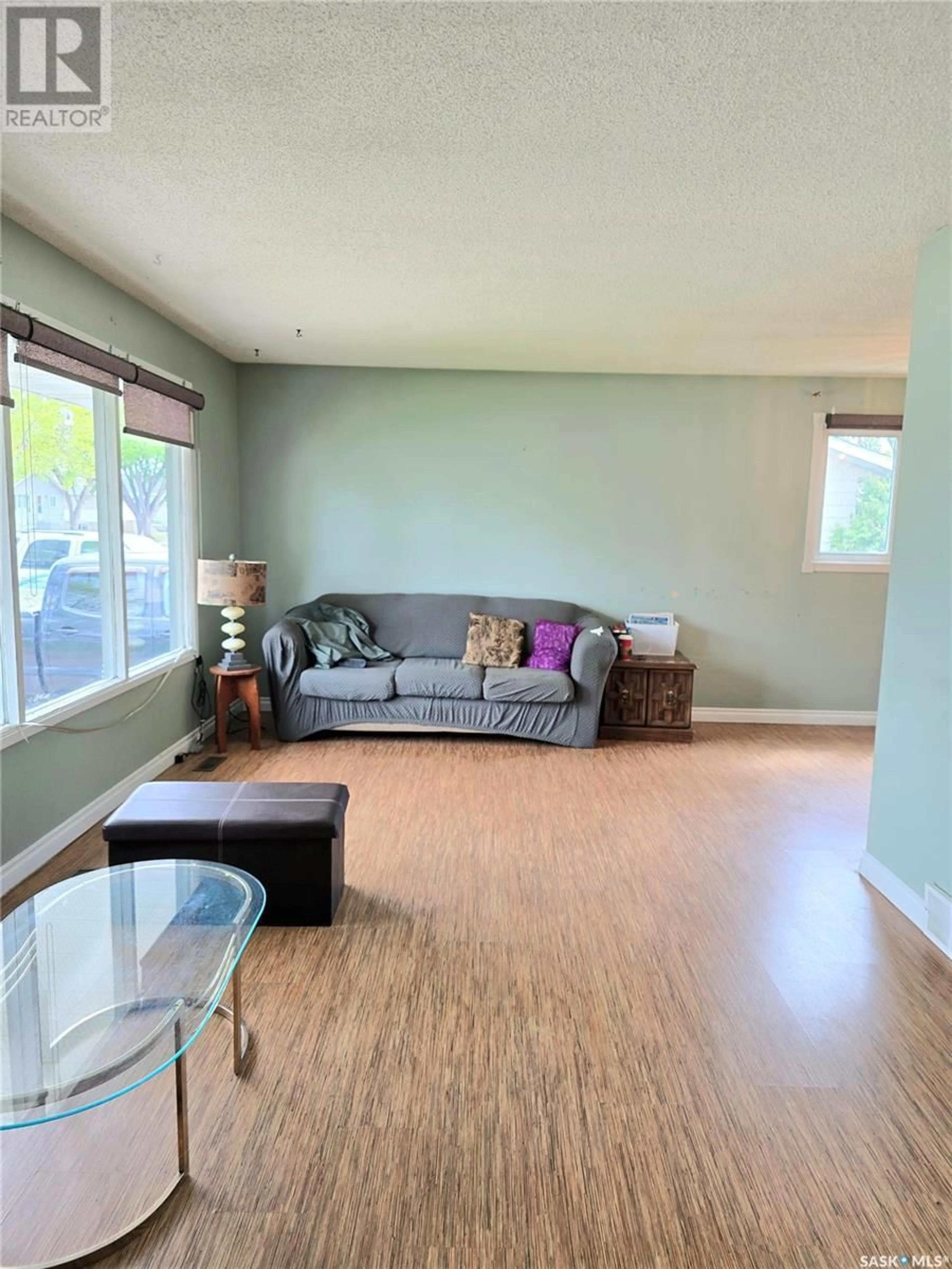 Living room with furniture, wood/laminate floor for 1809 C AVENUE, Saskatoon Saskatchewan S7L1L9