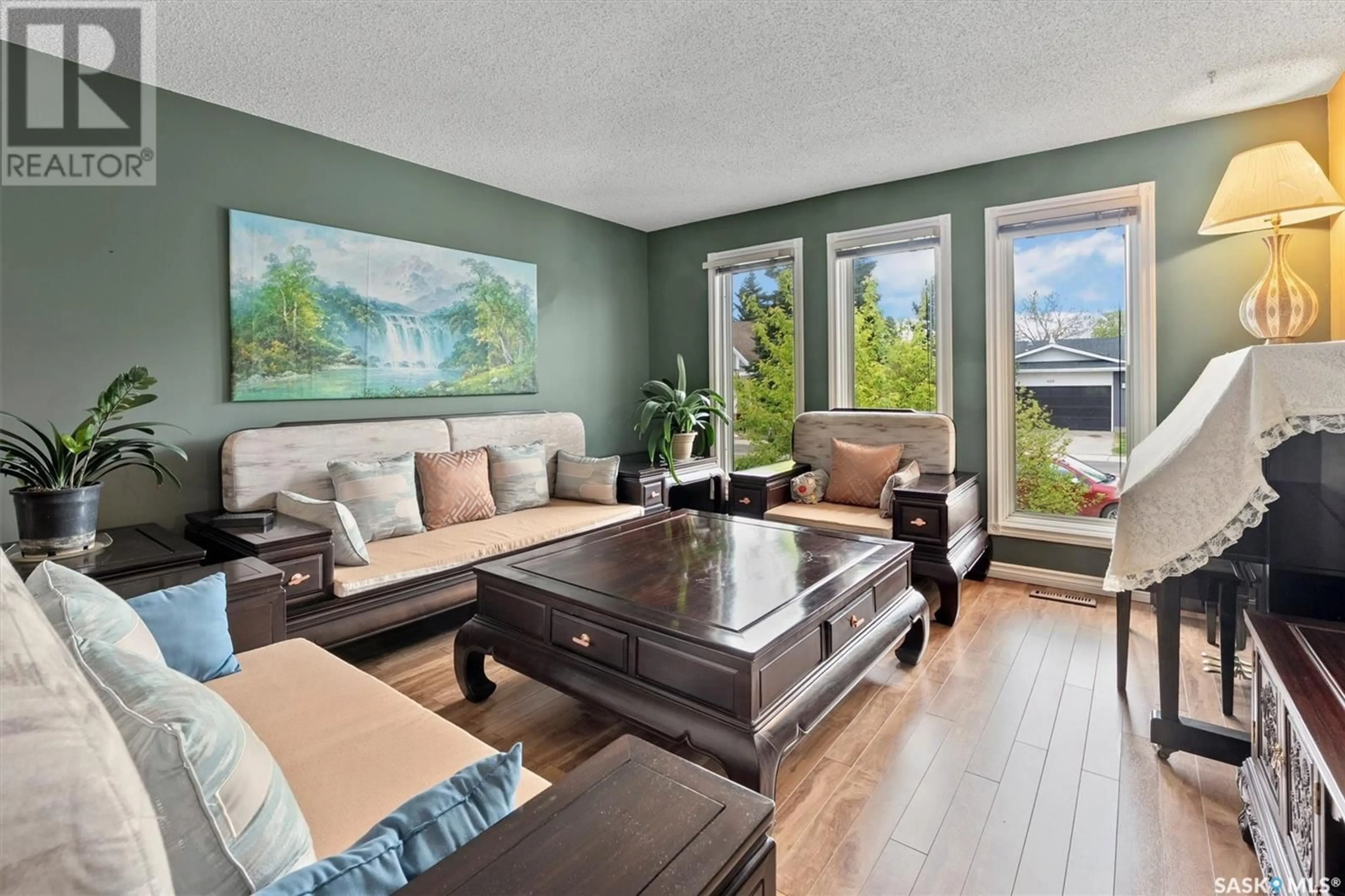 Living room with furniture, wood/laminate floor for 434 DELARONDE ROAD, Saskatoon Saskatchewan S7J3Y7