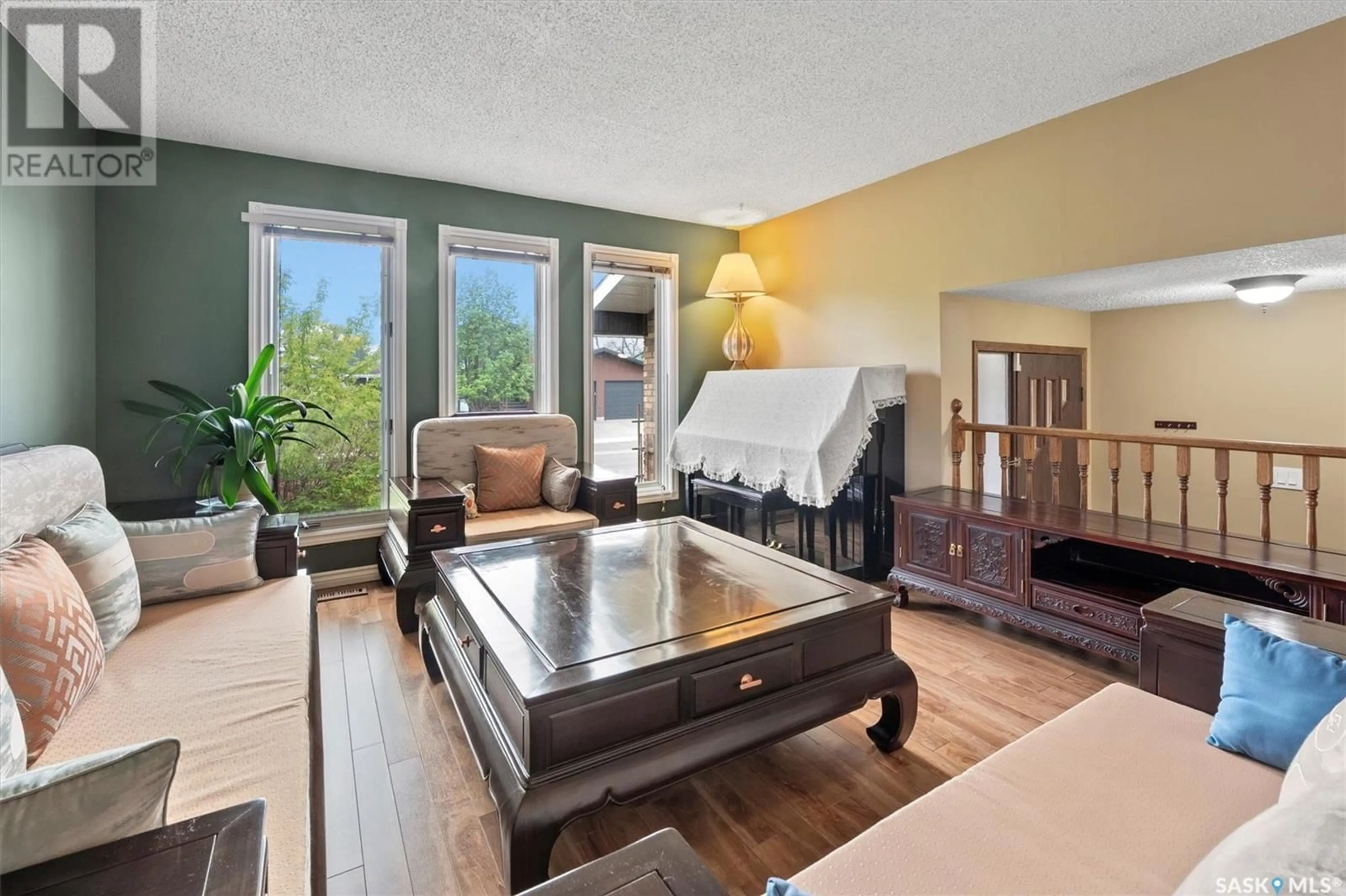 Living room with furniture, wood/laminate floor for 434 DELARONDE ROAD, Saskatoon Saskatchewan S7J3Y7