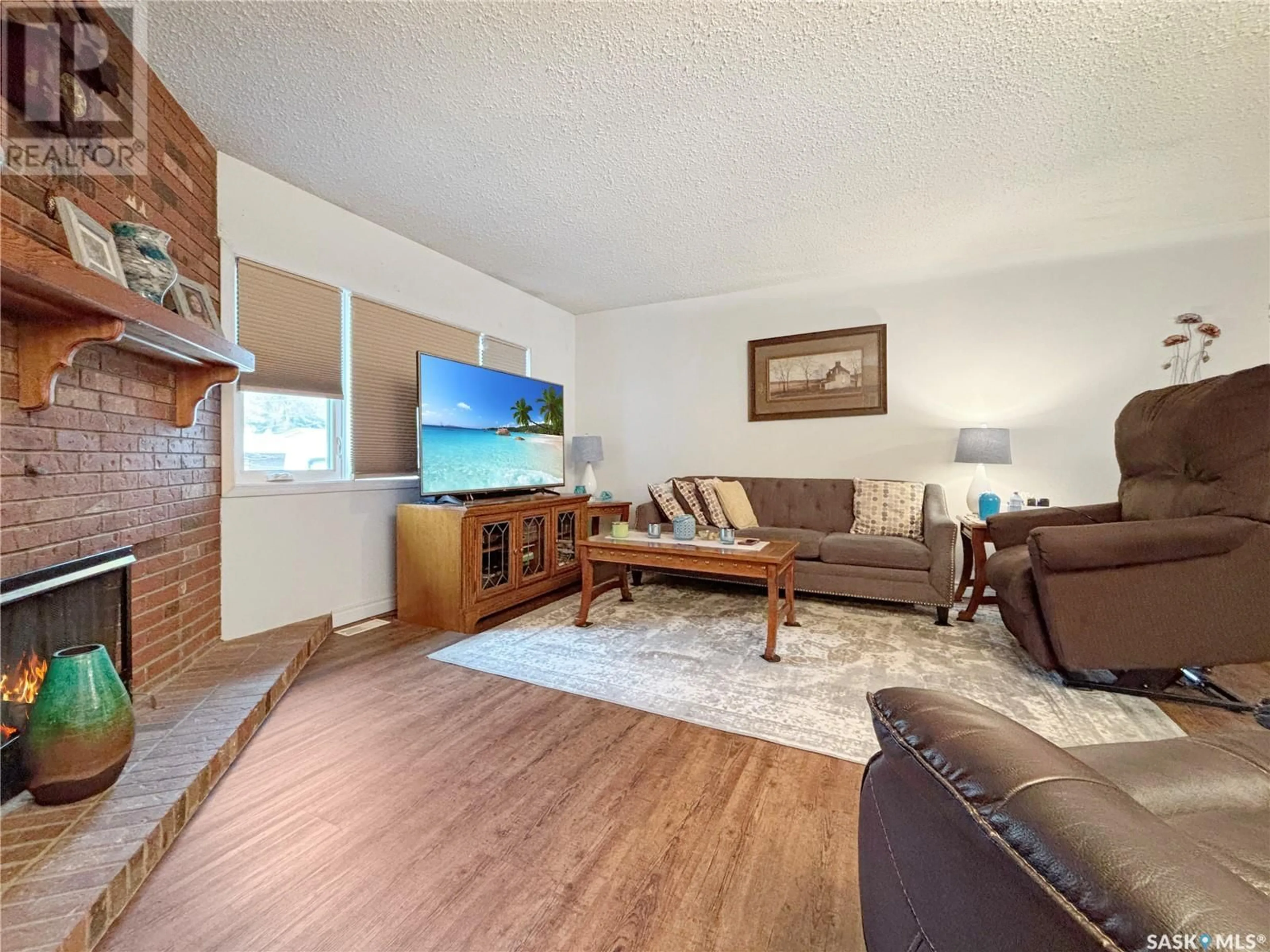 Living room with furniture, wood/laminate floor for 1812 CENTENNIAL CRESCENT, North Battleford Saskatchewan S9A3J3