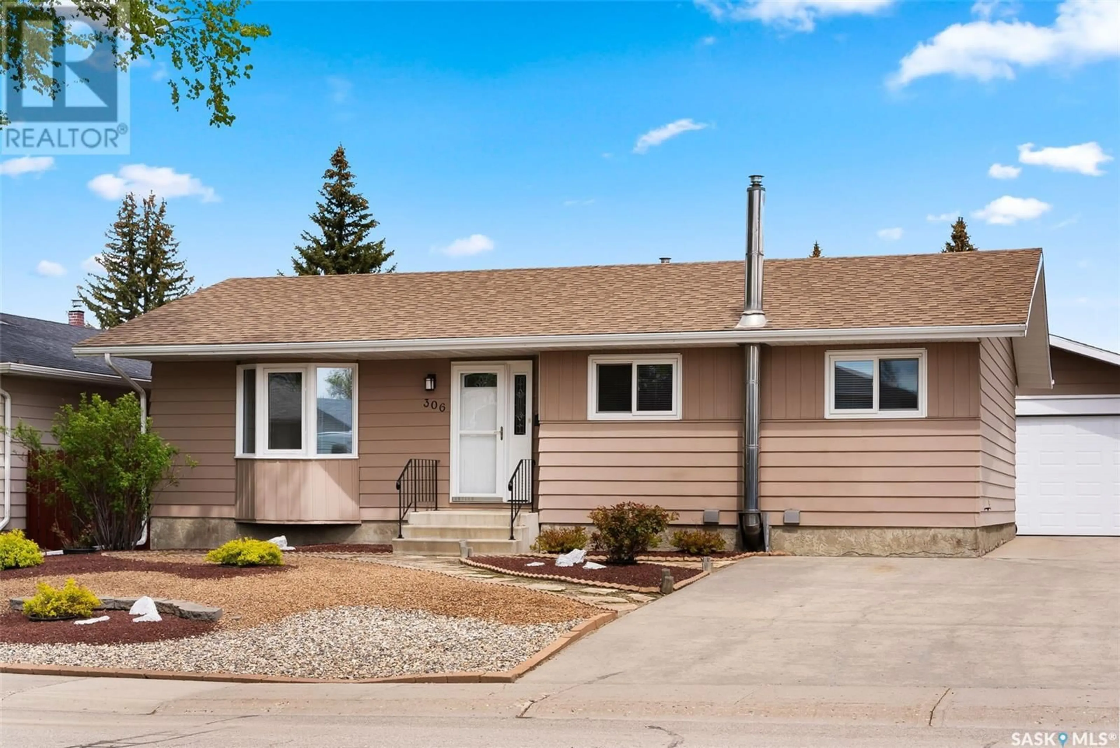 Home with vinyl exterior material, street for 306 RODENBUSH DRIVE, Regina Saskatchewan S4R6Y9
