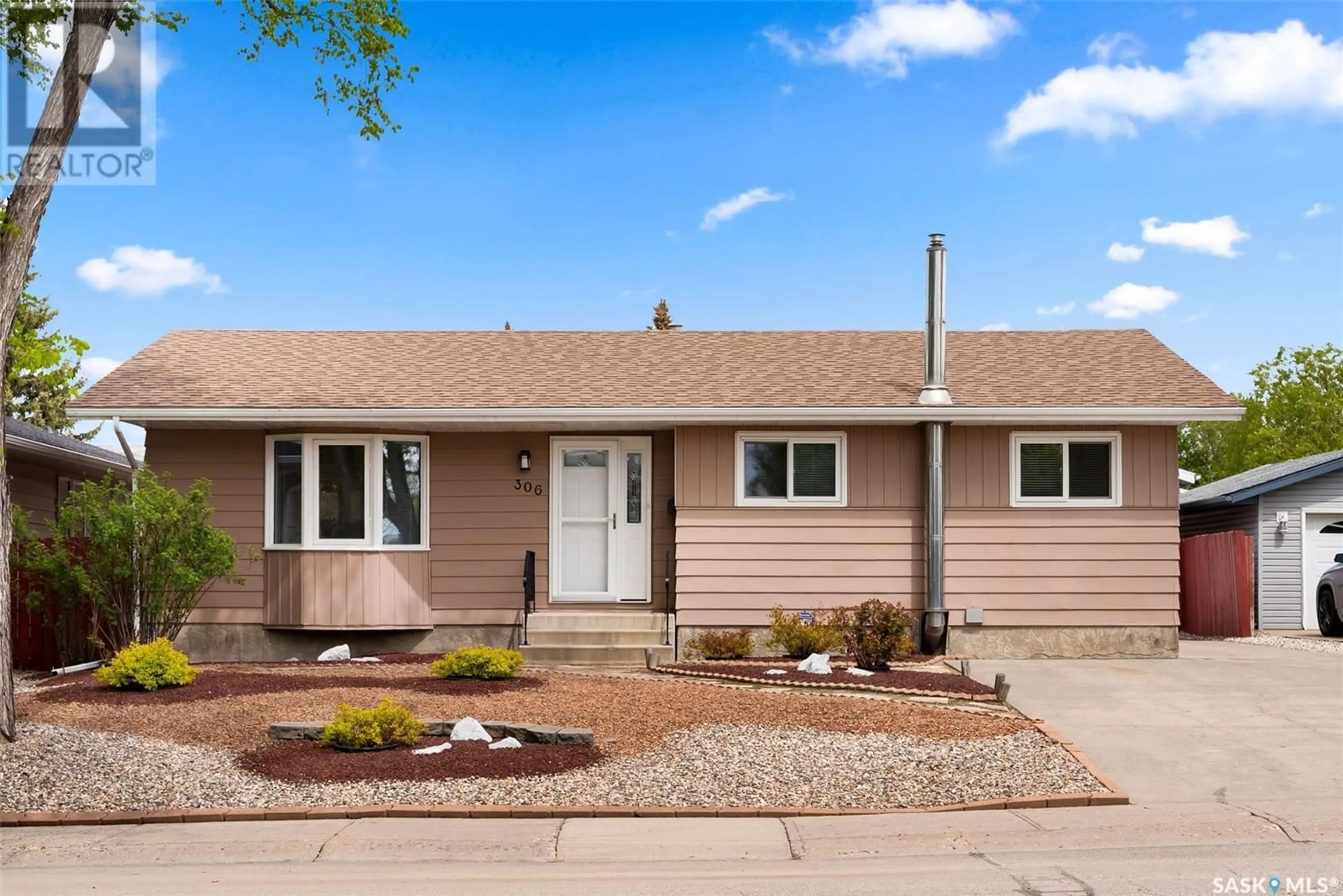 Home with vinyl exterior material, street for 306 RODENBUSH DRIVE, Regina Saskatchewan S4R6Y9