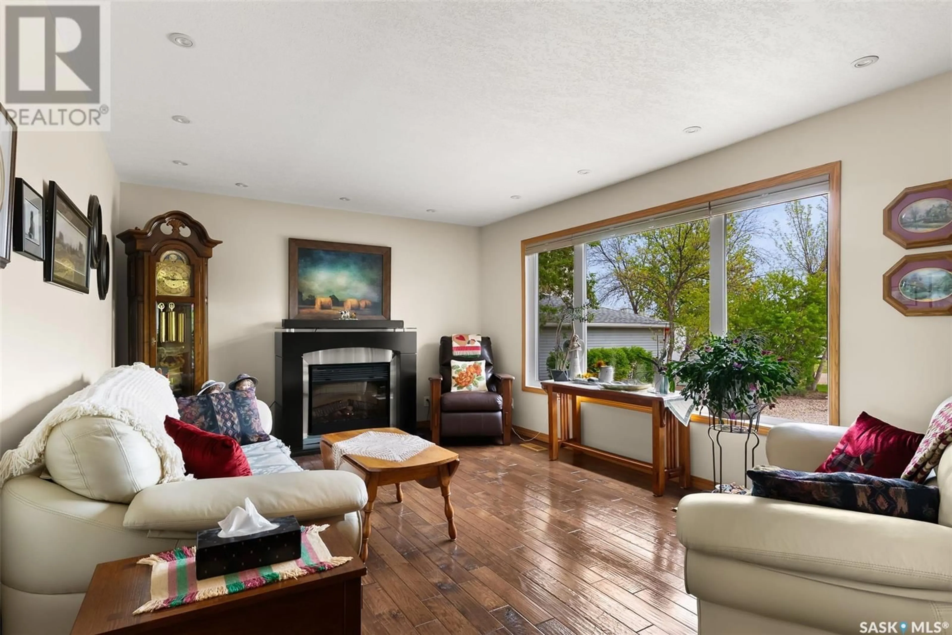 Living room with furniture, wood/laminate floor for 120 KINGBIRD DRIVE, Glen Harbour Saskatchewan S0G4L0