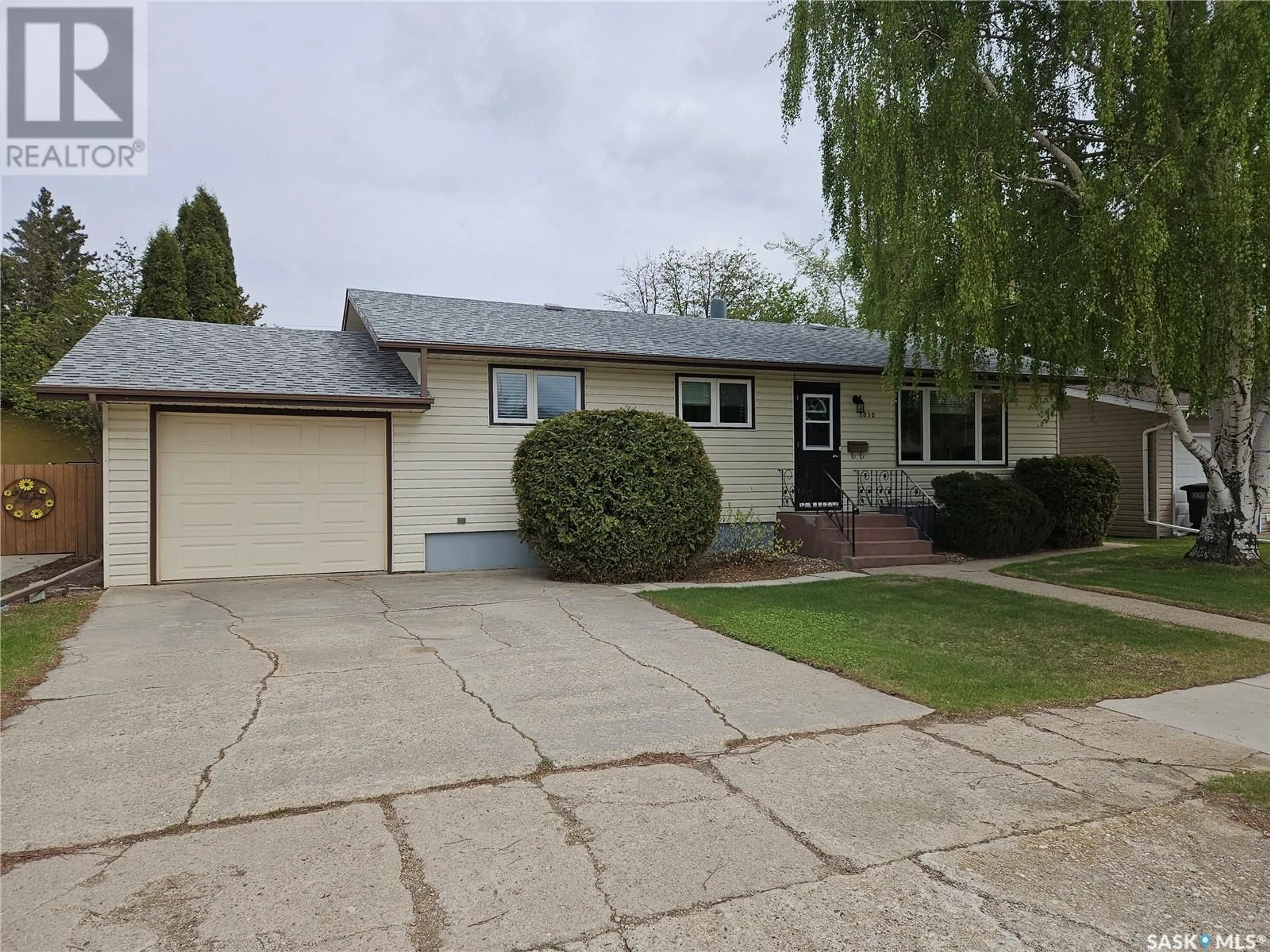 Home with vinyl exterior material, street for 1030 13TH STREET, Humboldt Saskatchewan S0K2A0