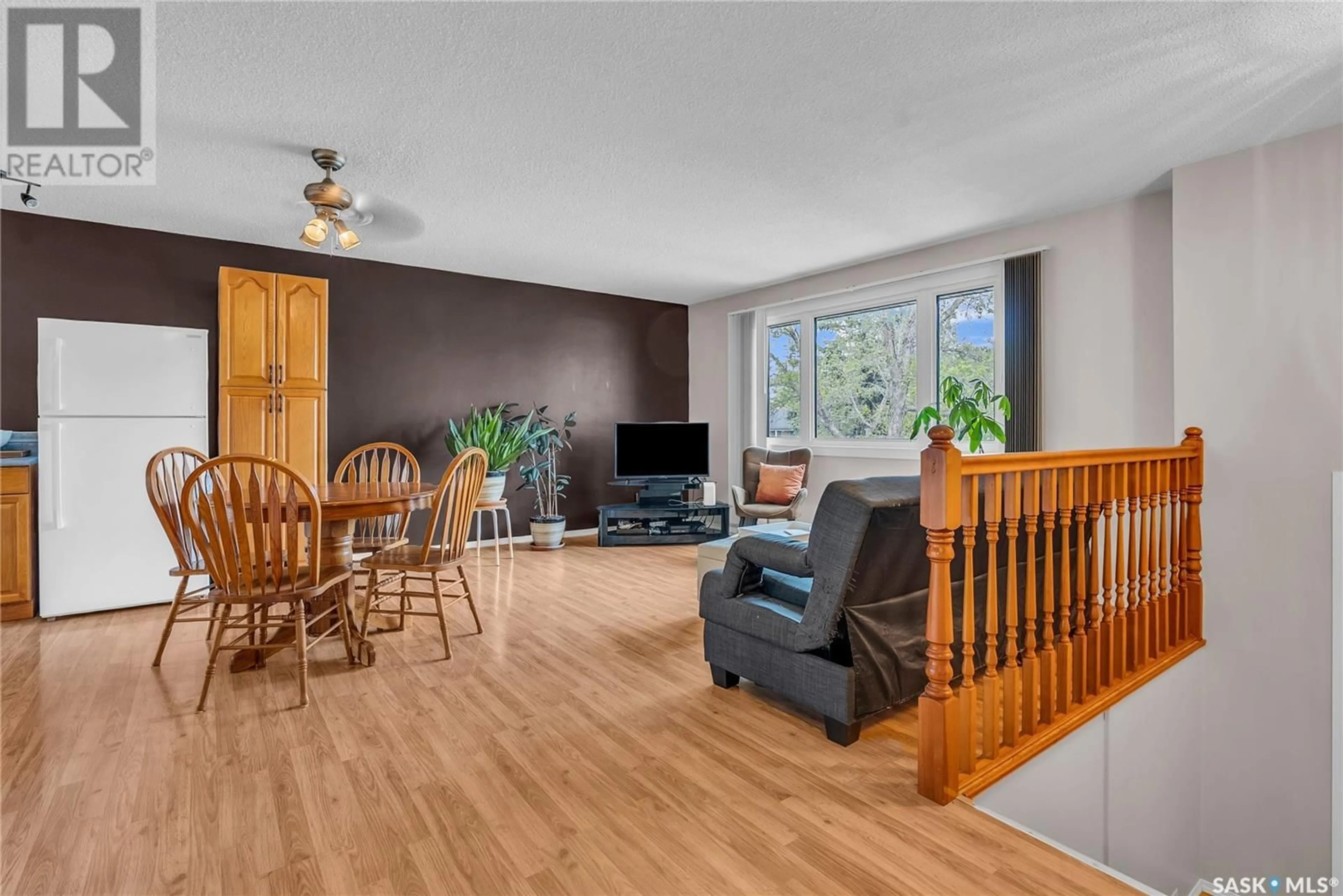 Living room with furniture, wood/laminate floor for 322 BALSAM CRESCENT, Saskatoon Saskatchewan S7N2M1
