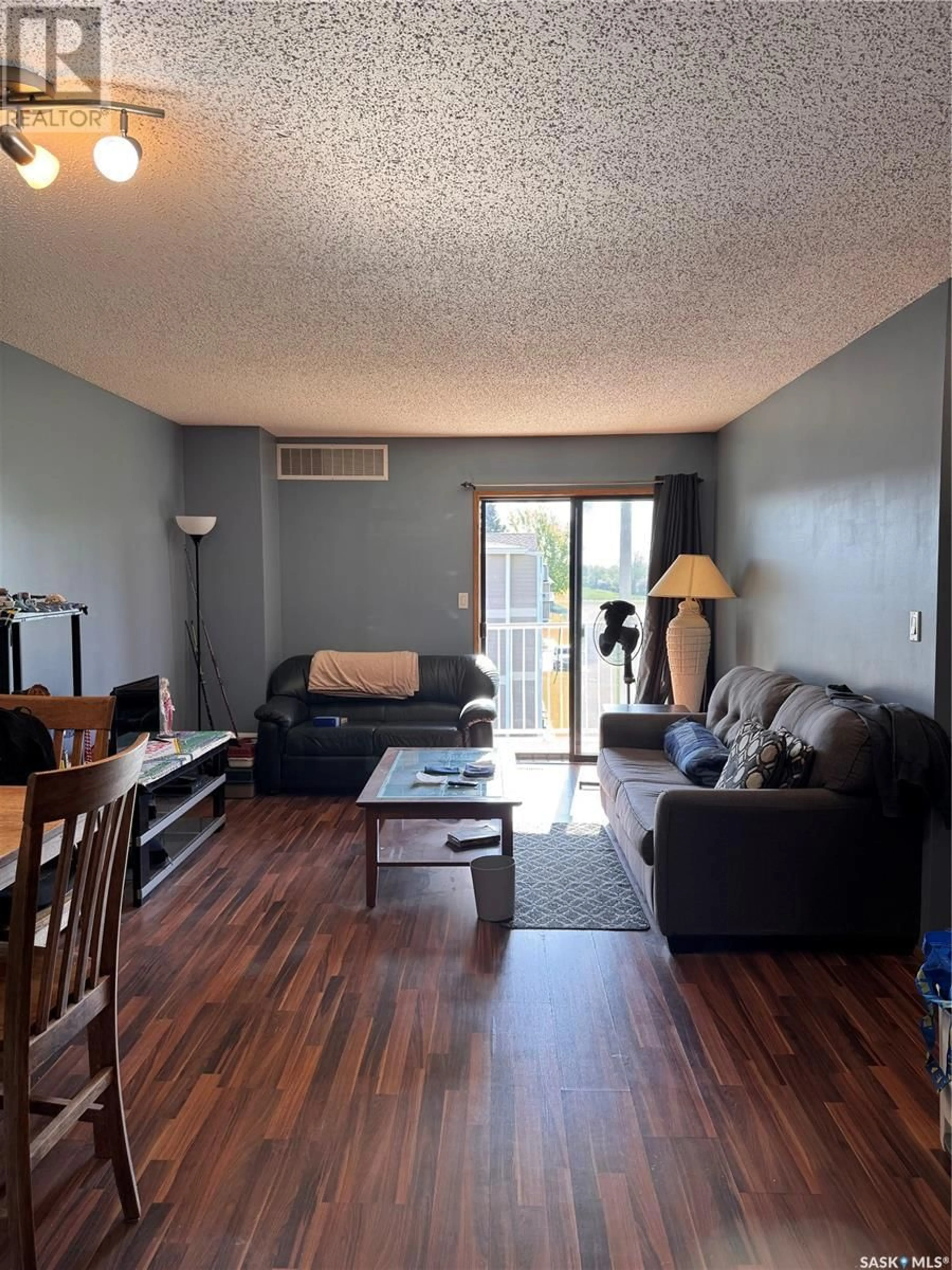 Living room with furniture, wood/laminate floor for 6595 - 19 ROCHDALE BOULEVARD, Regina Saskatchewan S4X2Z1