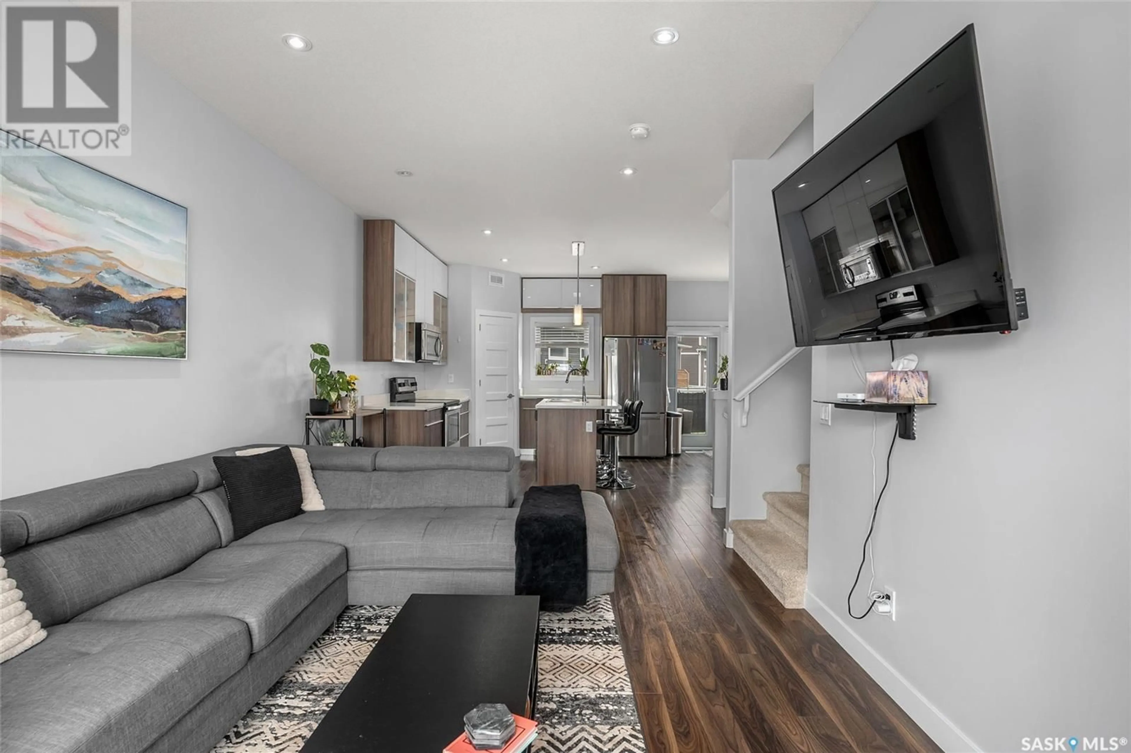 Living room with furniture, wood/laminate floor for 1020 EVERGREEN BOULEVARD, Saskatoon Saskatchewan S7W0V9