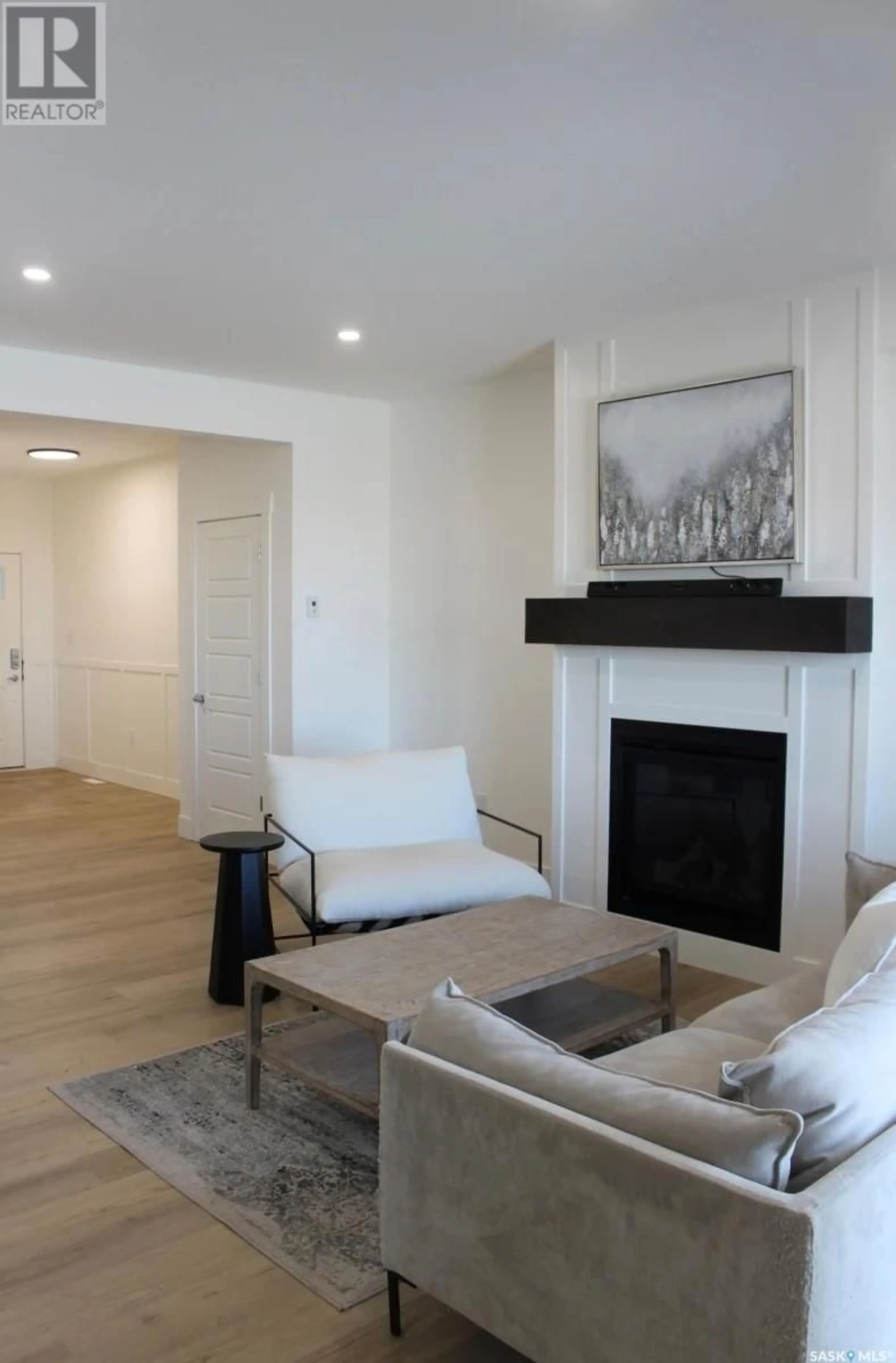 Living room with furniture, wood/laminate floor for 900 - 68 ST ANDREWS LANE, Warman Saskatchewan S0K4S4