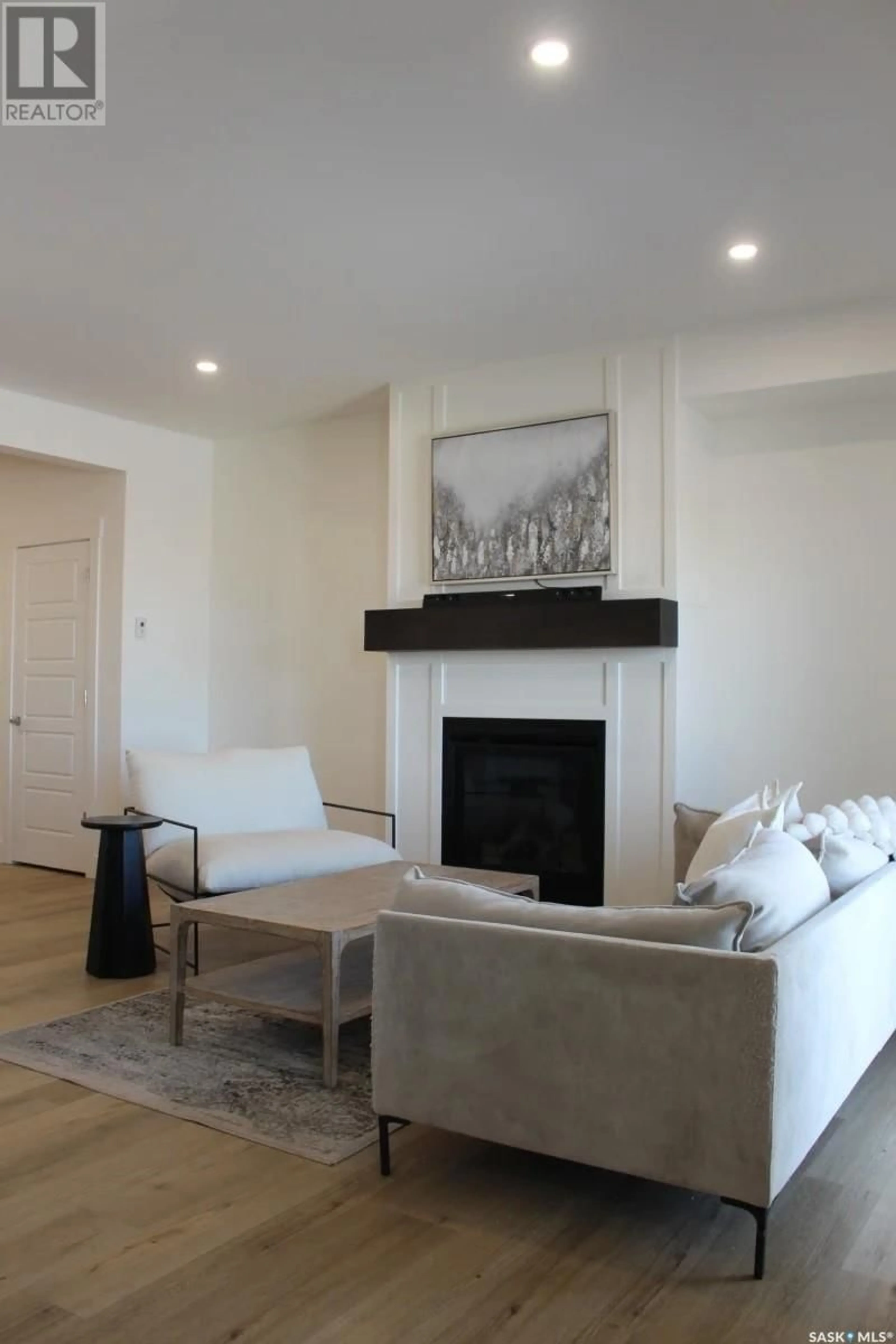 Living room with furniture, wood/laminate floor for 900 - 68 ST ANDREWS LANE, Warman Saskatchewan S0K4S4