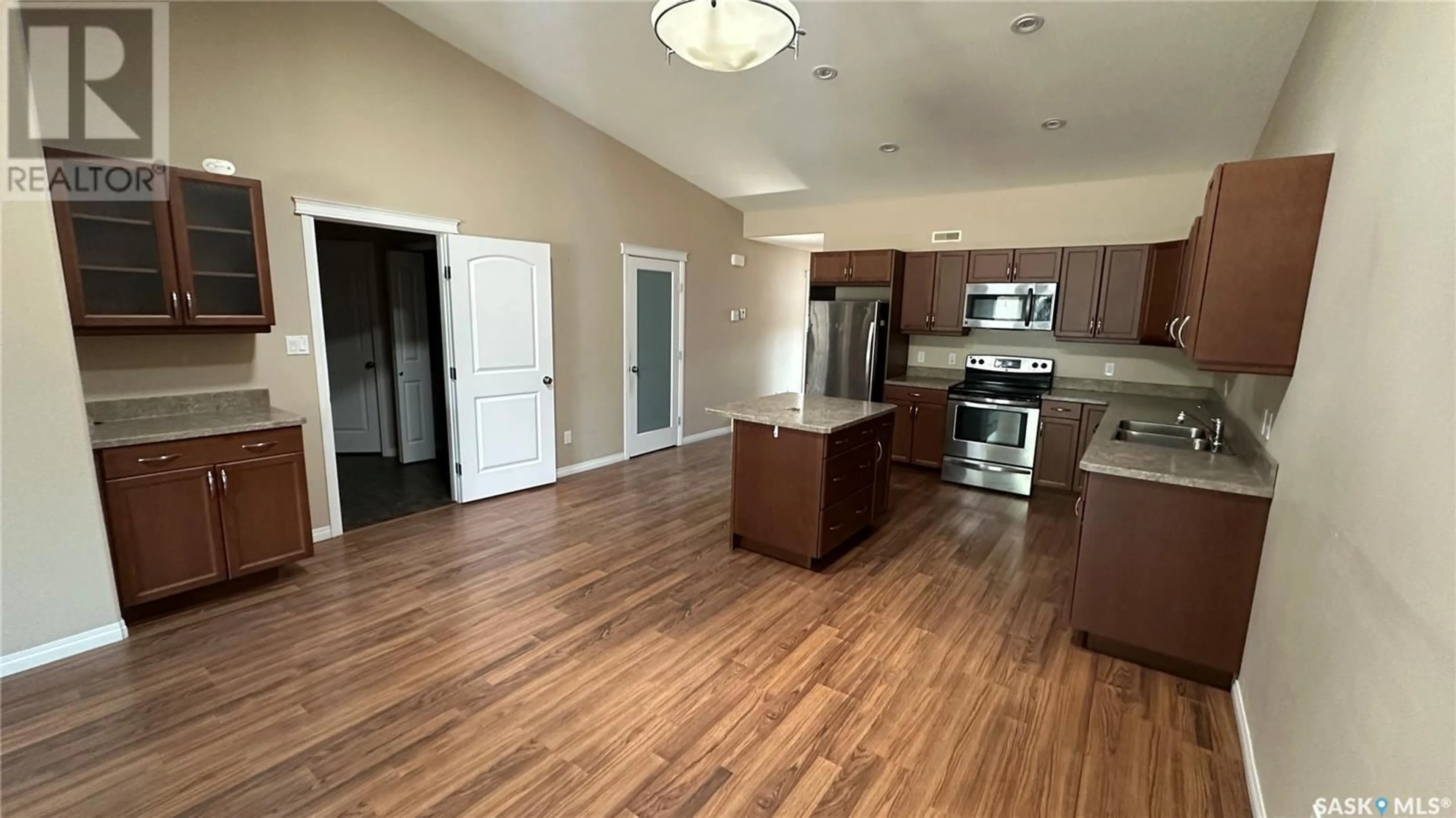 Open concept kitchen, wood/laminate floor for C - 1100 95TH AVENUE, Tisdale Saskatchewan S0E1T0