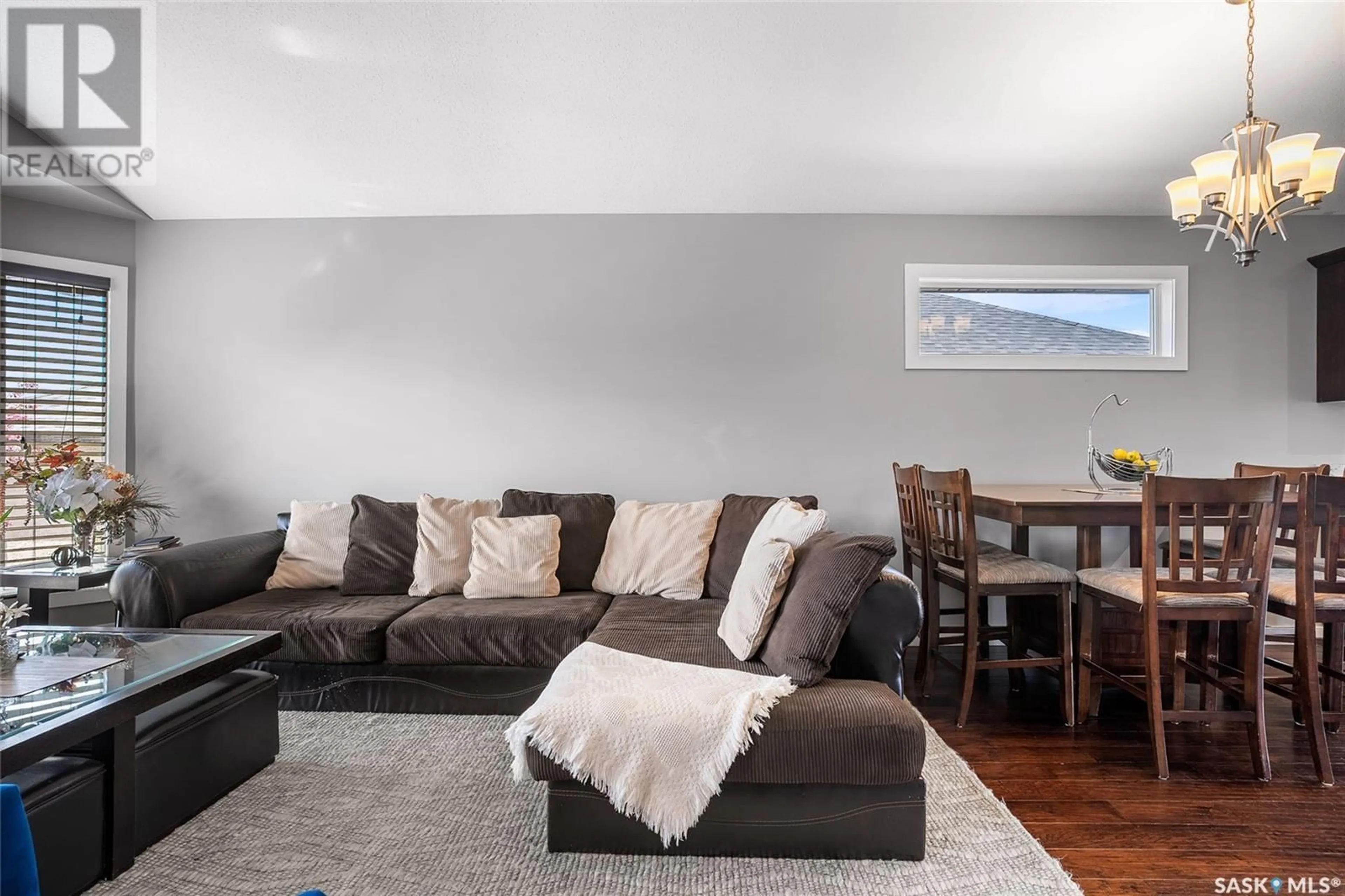 Living room with furniture, wood/laminate floor for 734 SUTTER CRESCENT, Saskatoon Saskatchewan S7T0R4