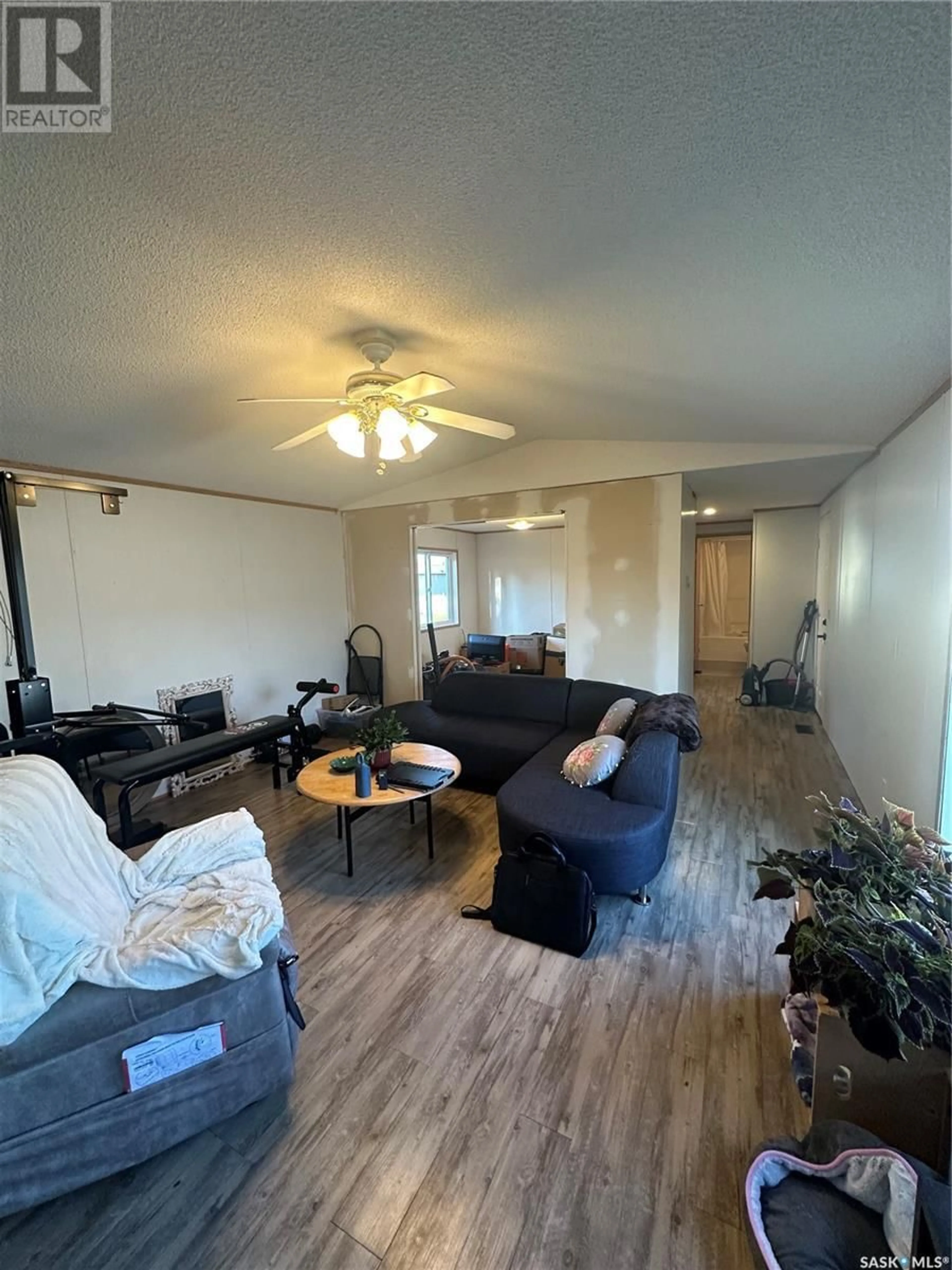 Living room with furniture, wood/laminate floor for 55 MULBERRY ROAD, Sunset Estates Saskatchewan S7B0A4