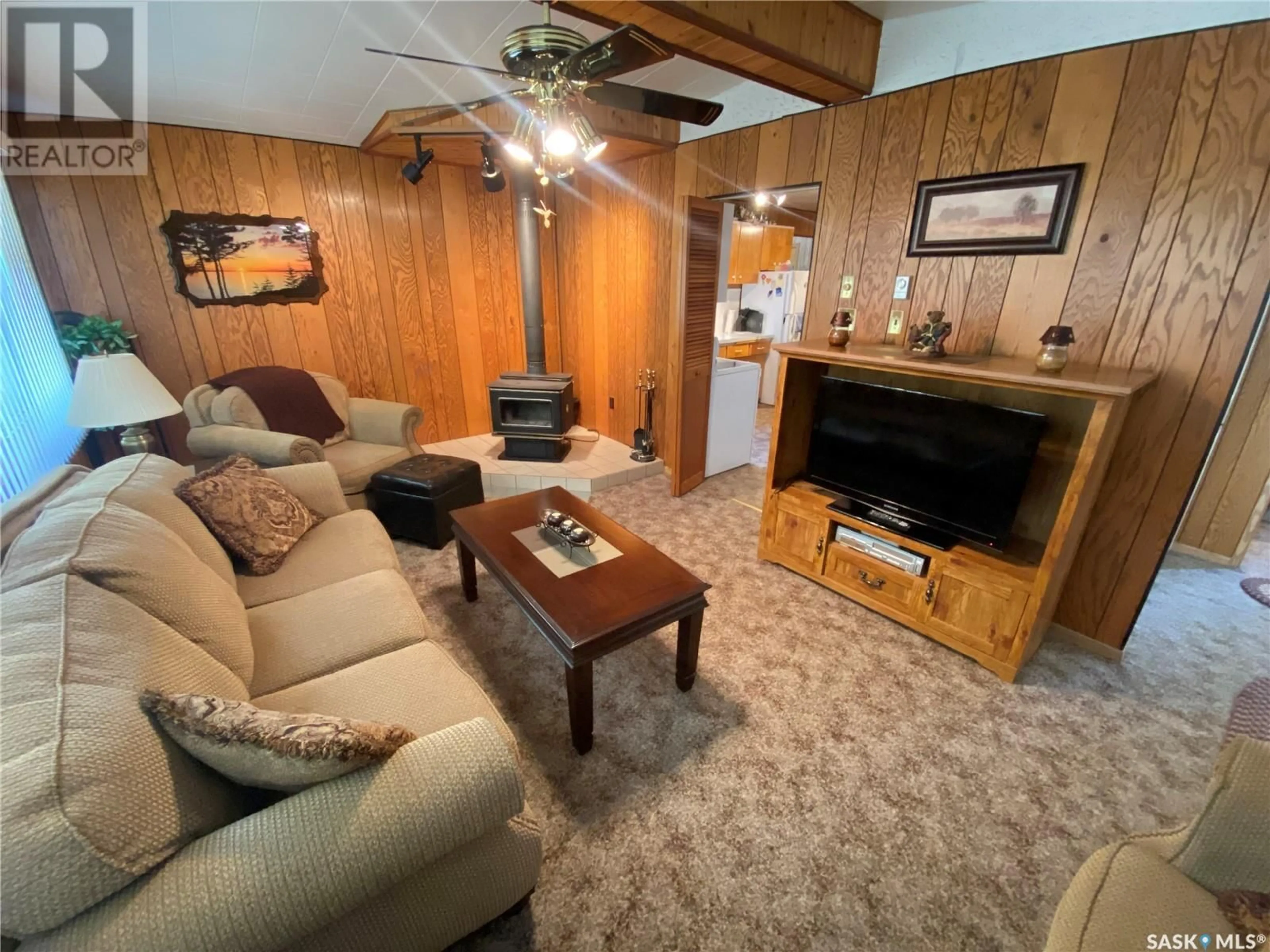Living room with furniture, wood/laminate floor for 105 DENNIS DRIVE, Good Spirit Acres Saskatchewan S0A0L1