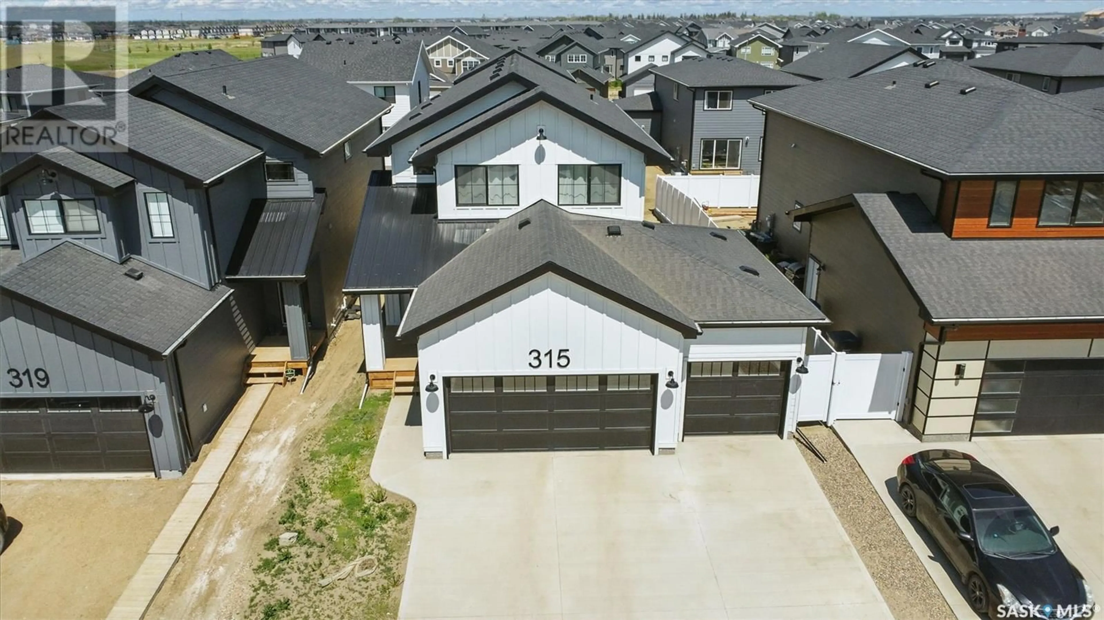 A pic from outside/outdoor area/front of a property/back of a property/a pic from drone, street for 315 DZIADYK BEND, Saskatoon Saskatchewan S7V1M5
