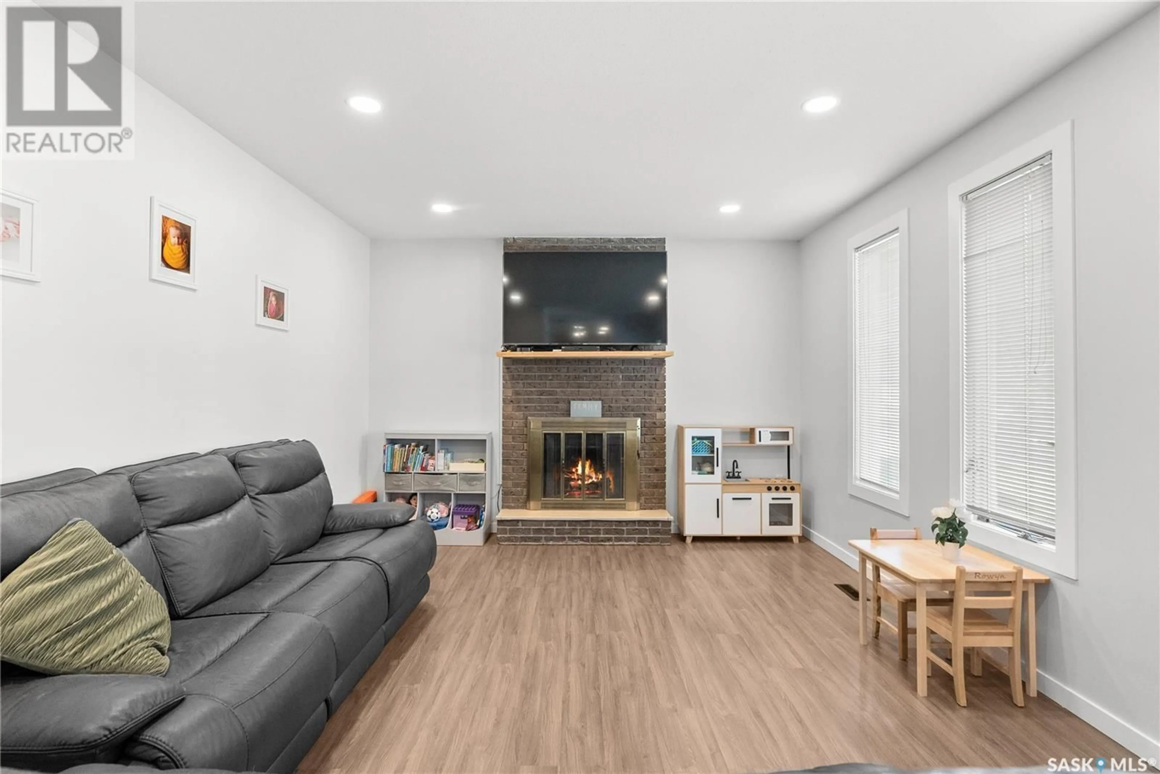 Living room with furniture, wood/laminate floor for 501 WILKEN CRESCENT, Warman Saskatchewan S0K4S0