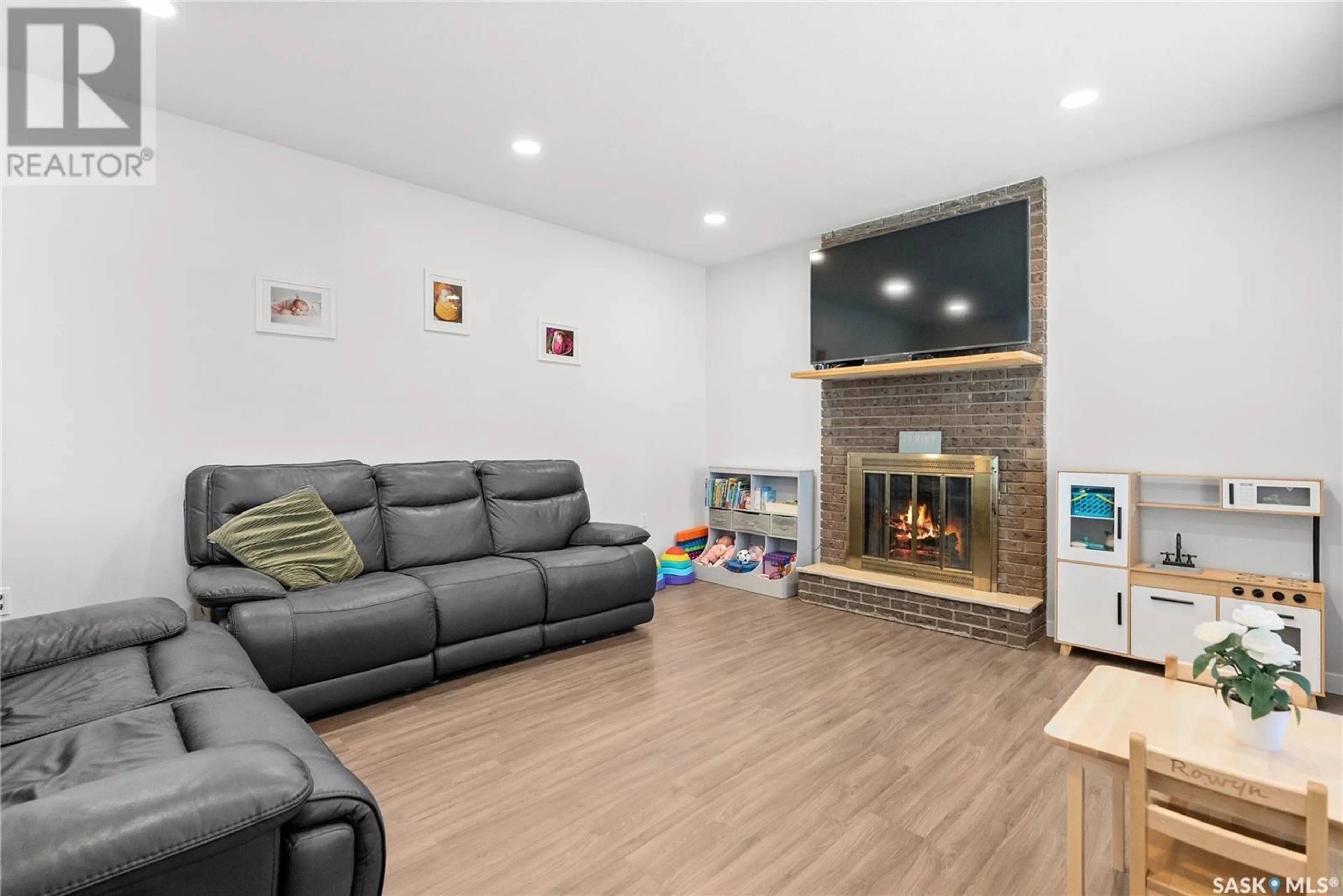 Living room with furniture, wood/laminate floor for 501 WILKEN CRESCENT, Warman Saskatchewan S0K4S0