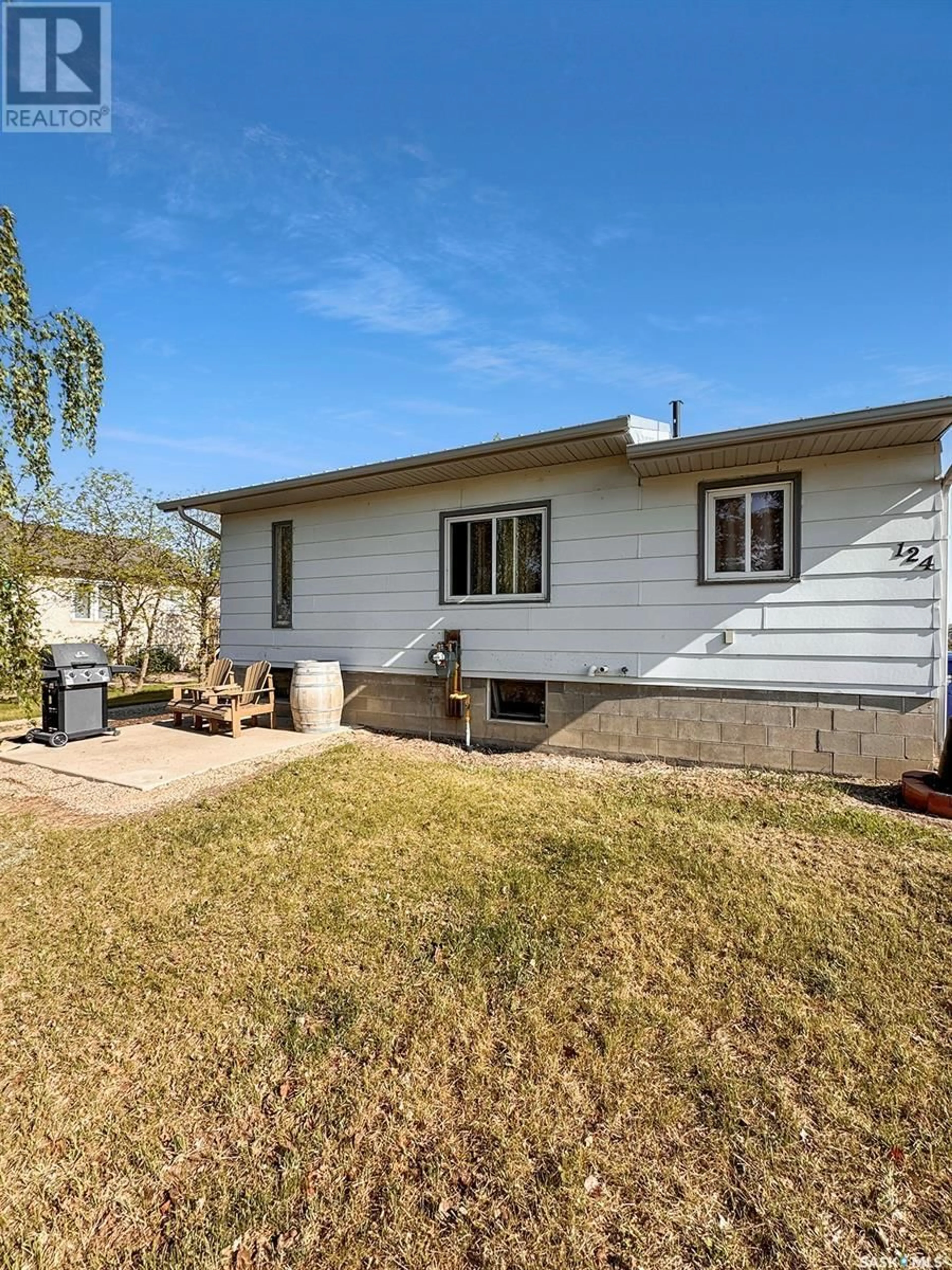 Home with vinyl exterior material, street for 124 SOUTH SERVICE ROAD, Hague Saskatchewan S0K1X0