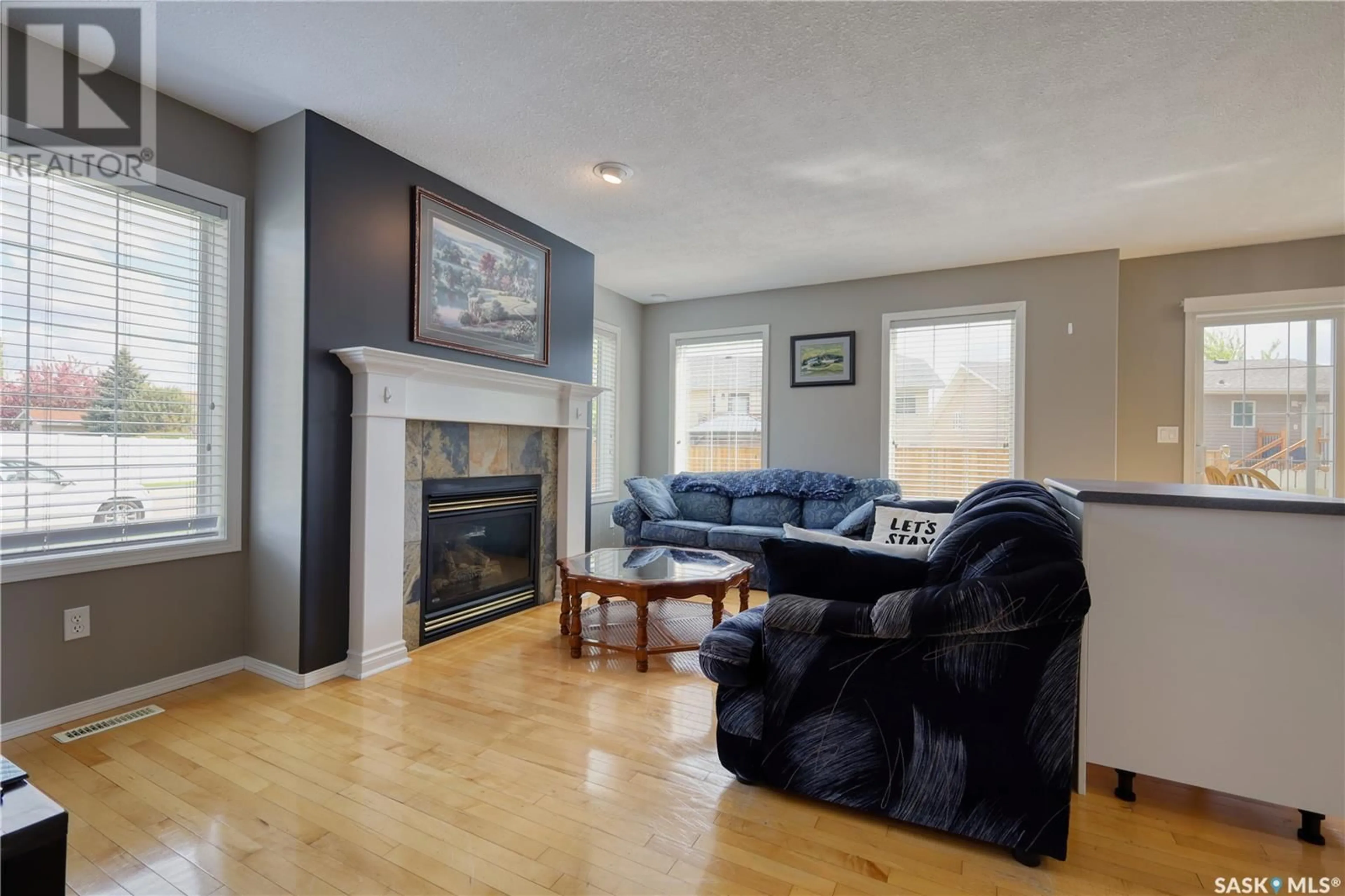 Living room with furniture, wood/laminate floor for 1 111 FAIRBROTHER CRESCENT, Saskatoon Saskatchewan S7S1L3