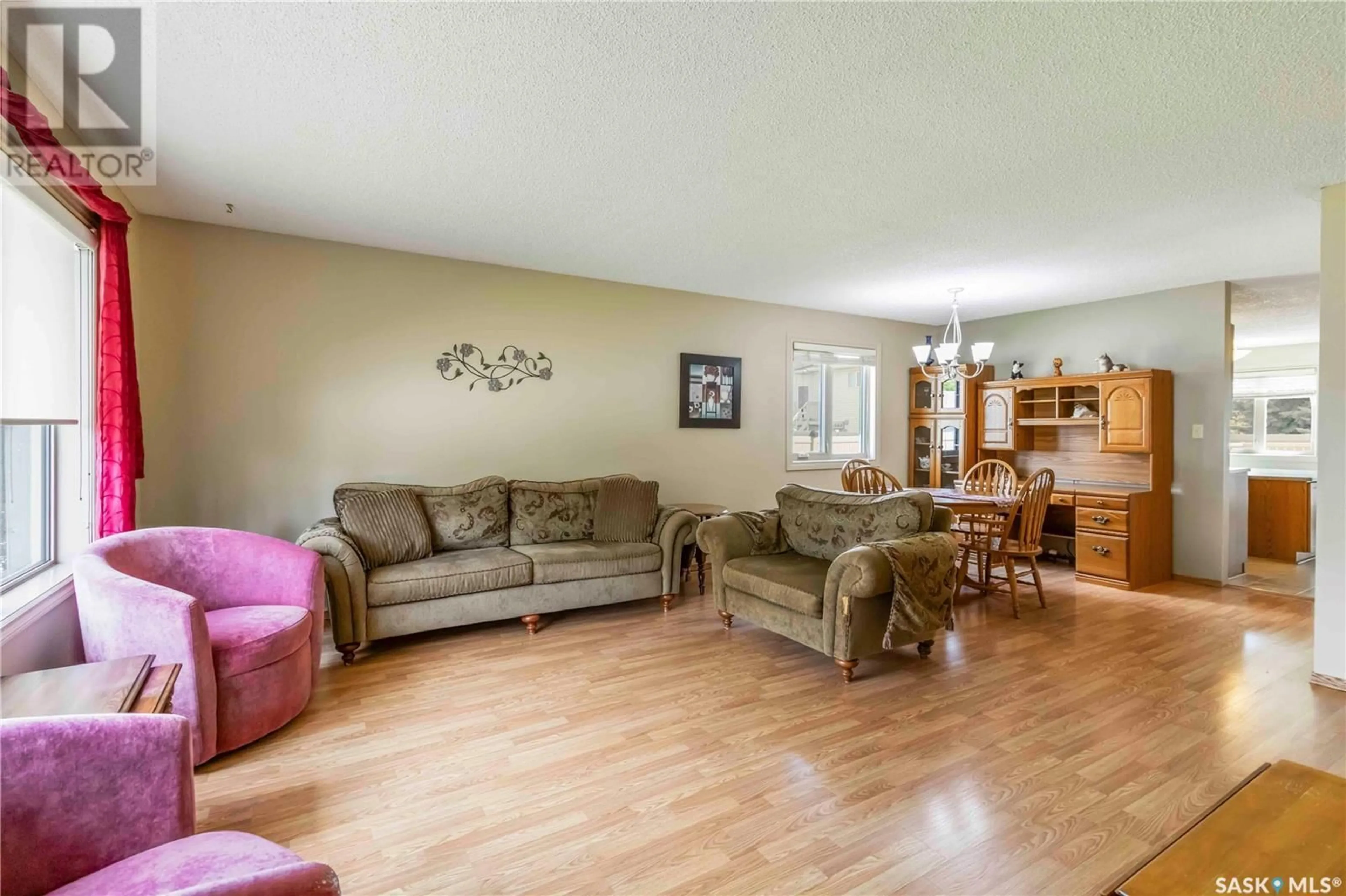 Living room with furniture, wood/laminate floor for 2510 - 410 KENDERDINE ROAD, Saskatoon Saskatchewan S7N4G5