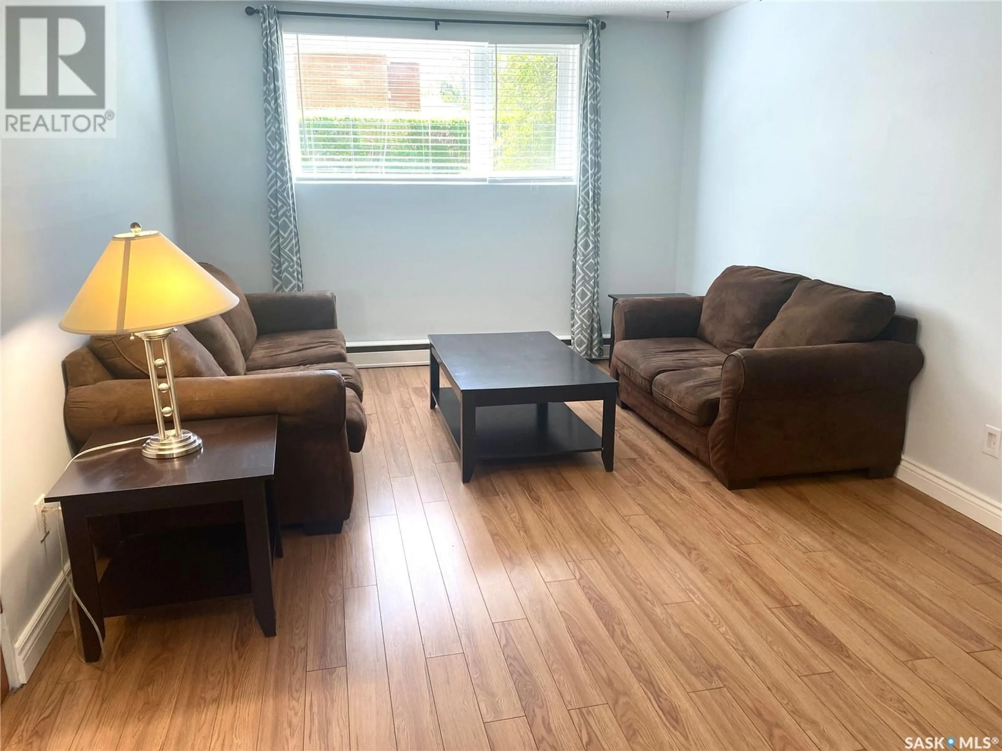 Living room with furniture, wood/laminate floor for 1 NEILL PLACE, Regina Saskatchewan S4N2V4