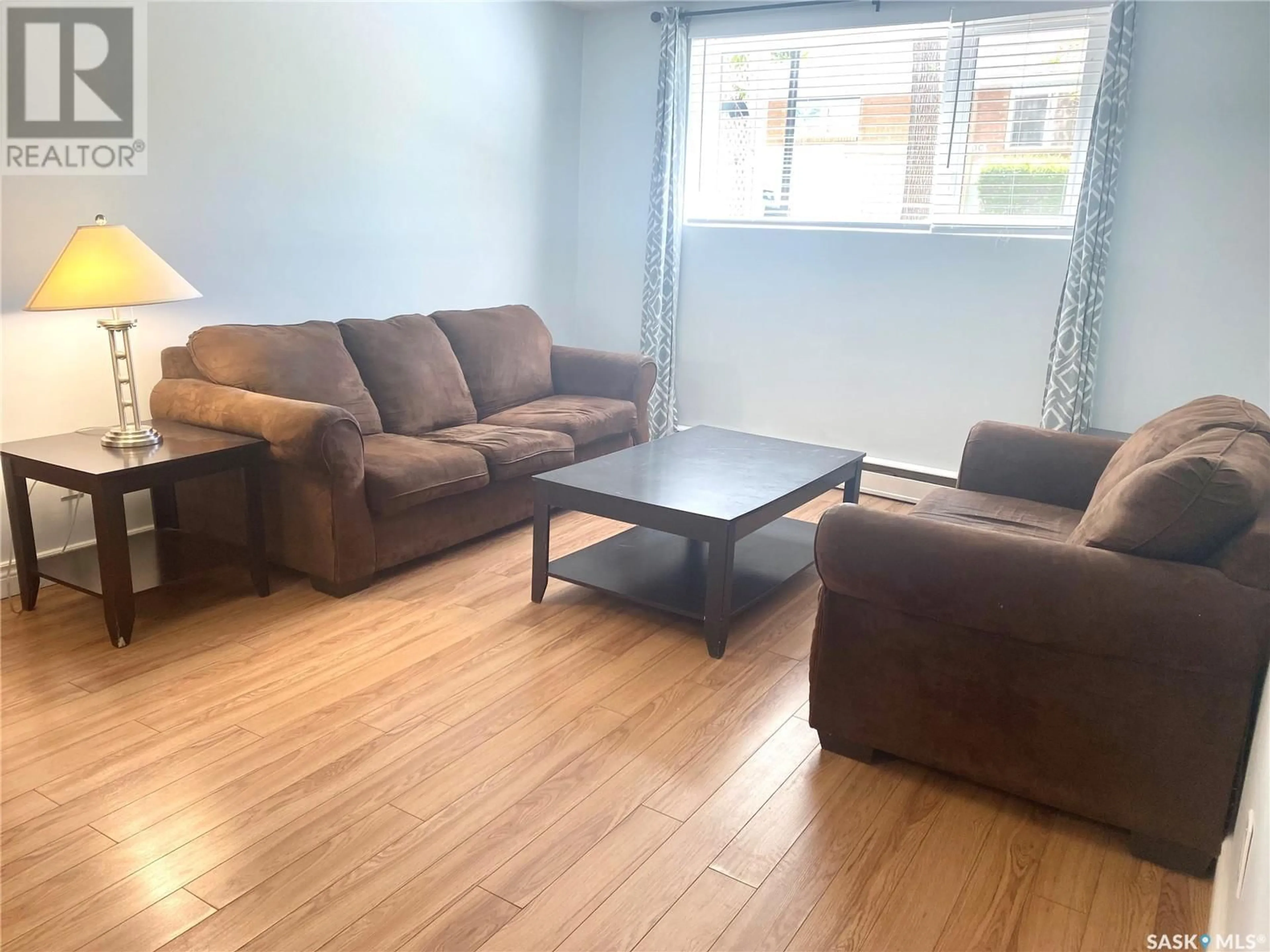 Living room with furniture, wood/laminate floor for 1 NEILL PLACE, Regina Saskatchewan S4N2V4