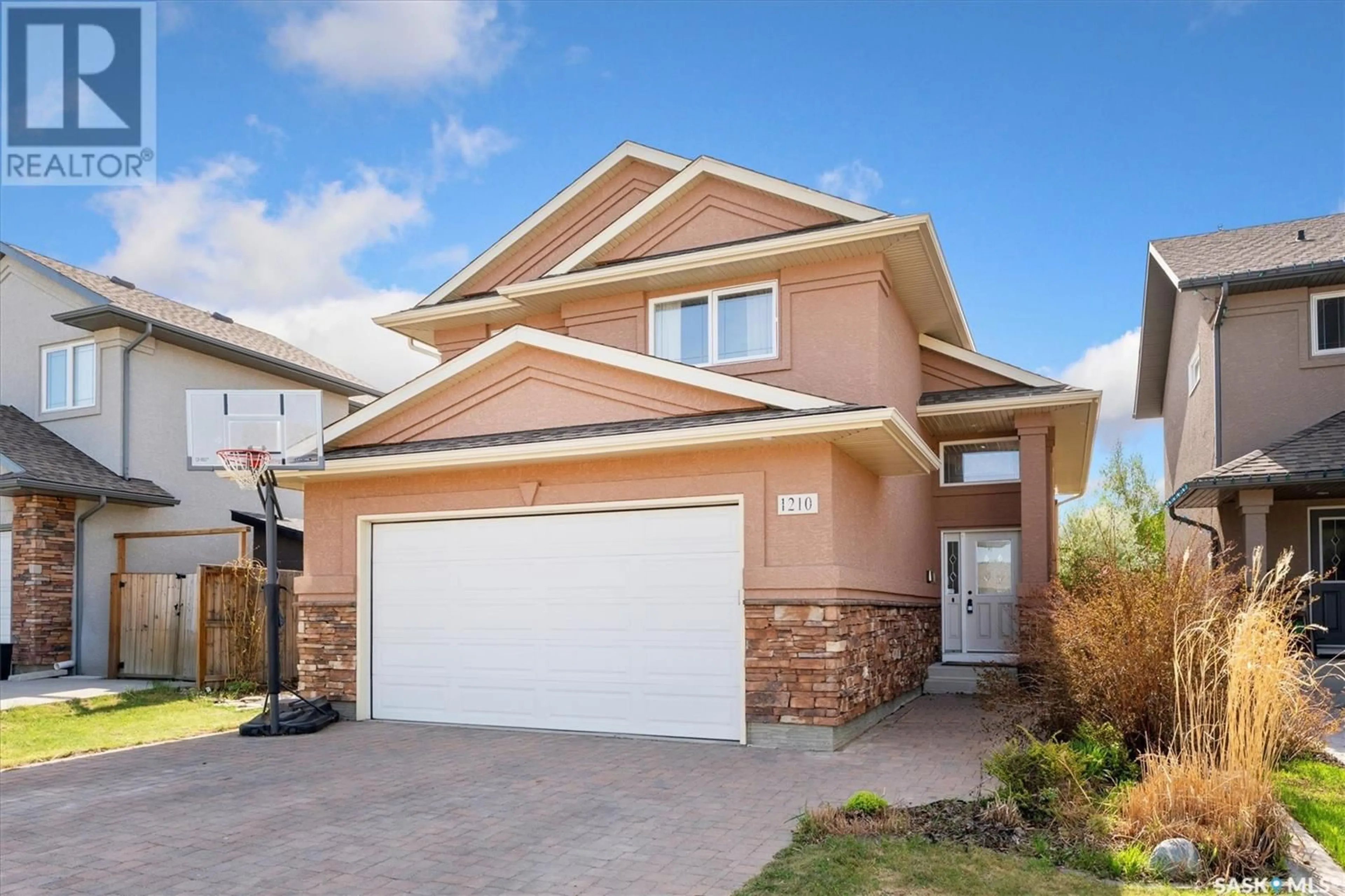 Home with vinyl exterior material, street for 1210 REMPEL CRESCENT, Saskatoon Saskatchewan S7T0M2