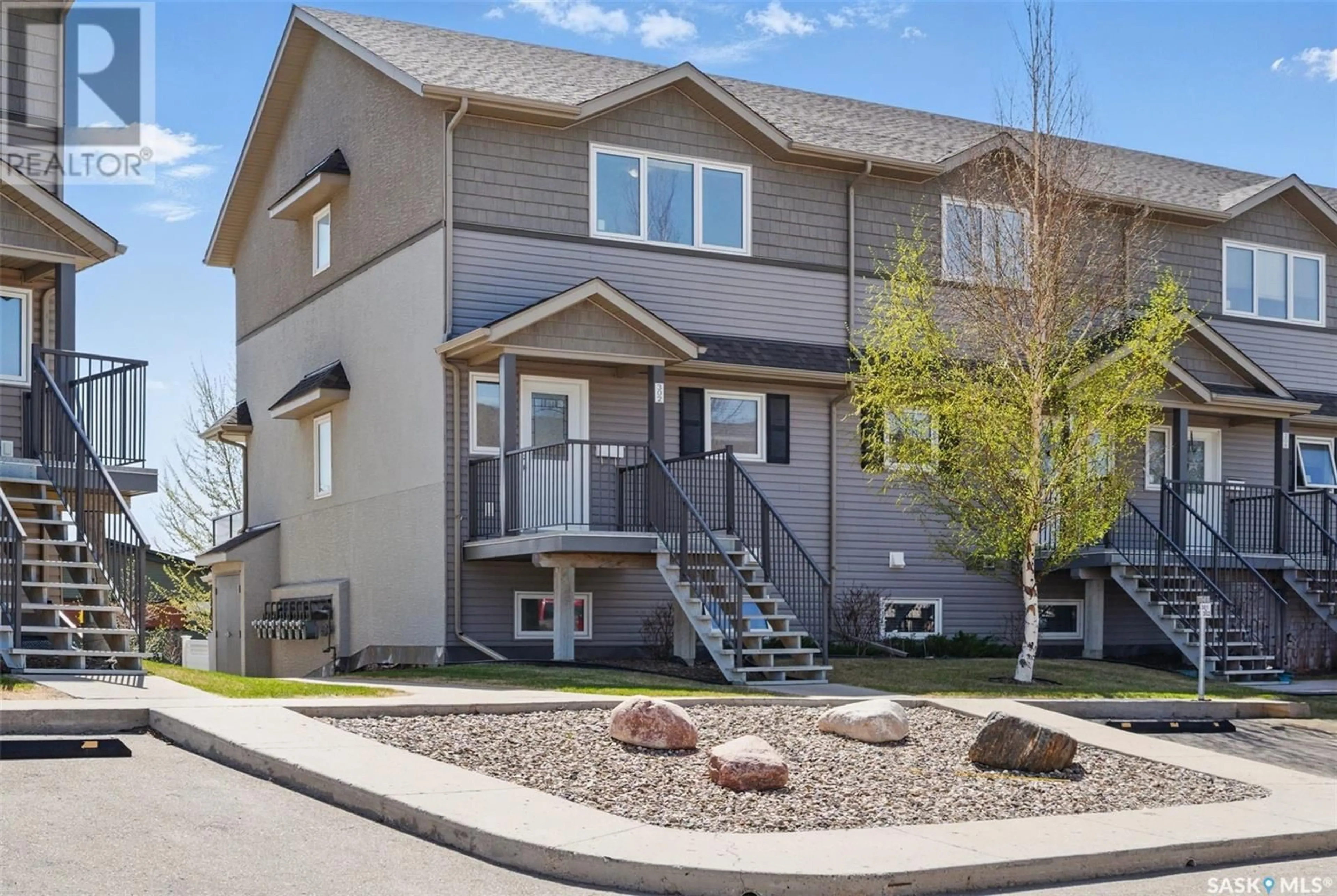 Home with vinyl exterior material, street for 115 - 302 DALGLEISH LINK, Saskatoon Saskatchewan S7W0N5