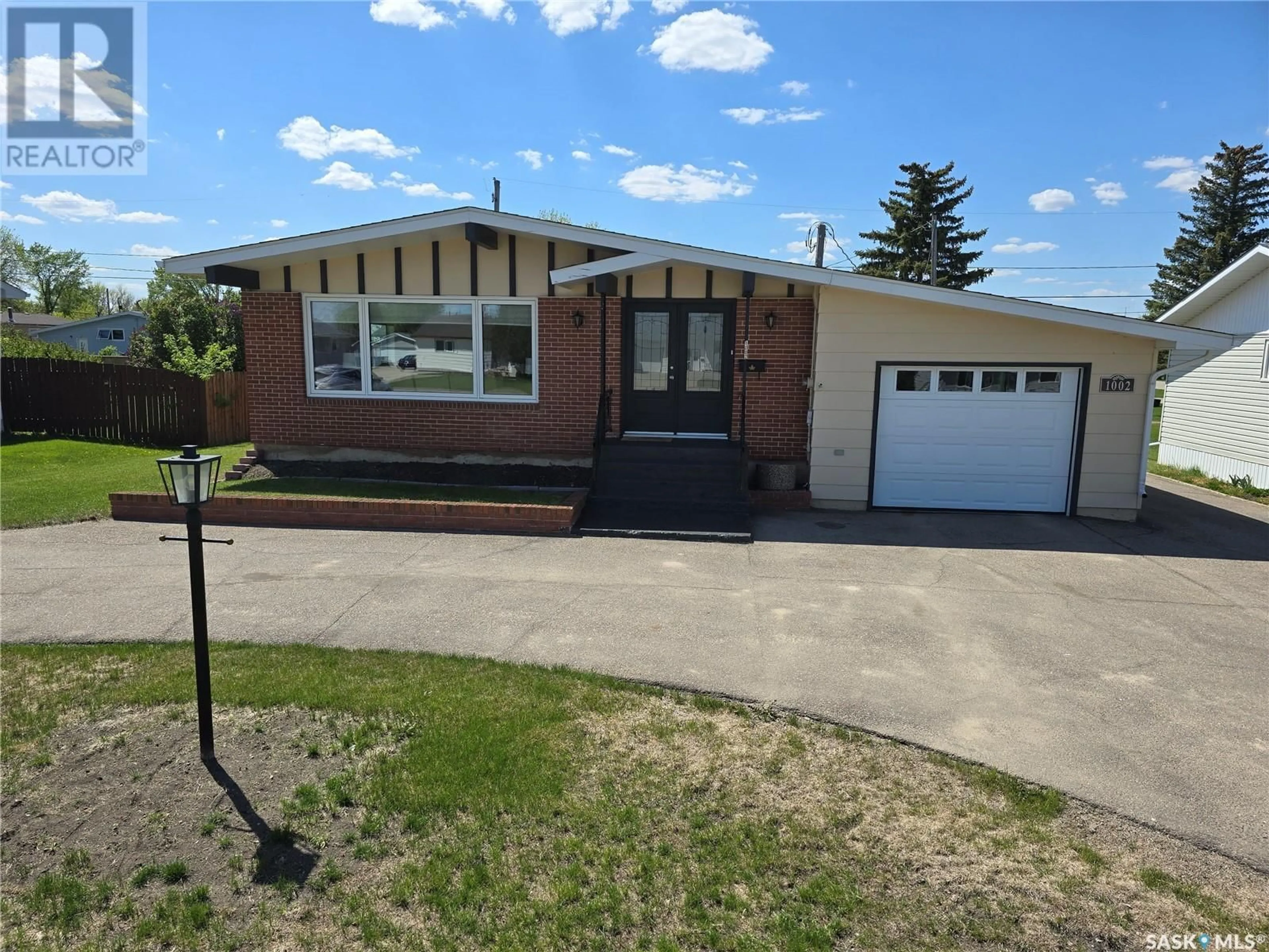 Home with brick exterior material, street for 1002 DESMOND STREET, Grenfell Saskatchewan S0G2B0